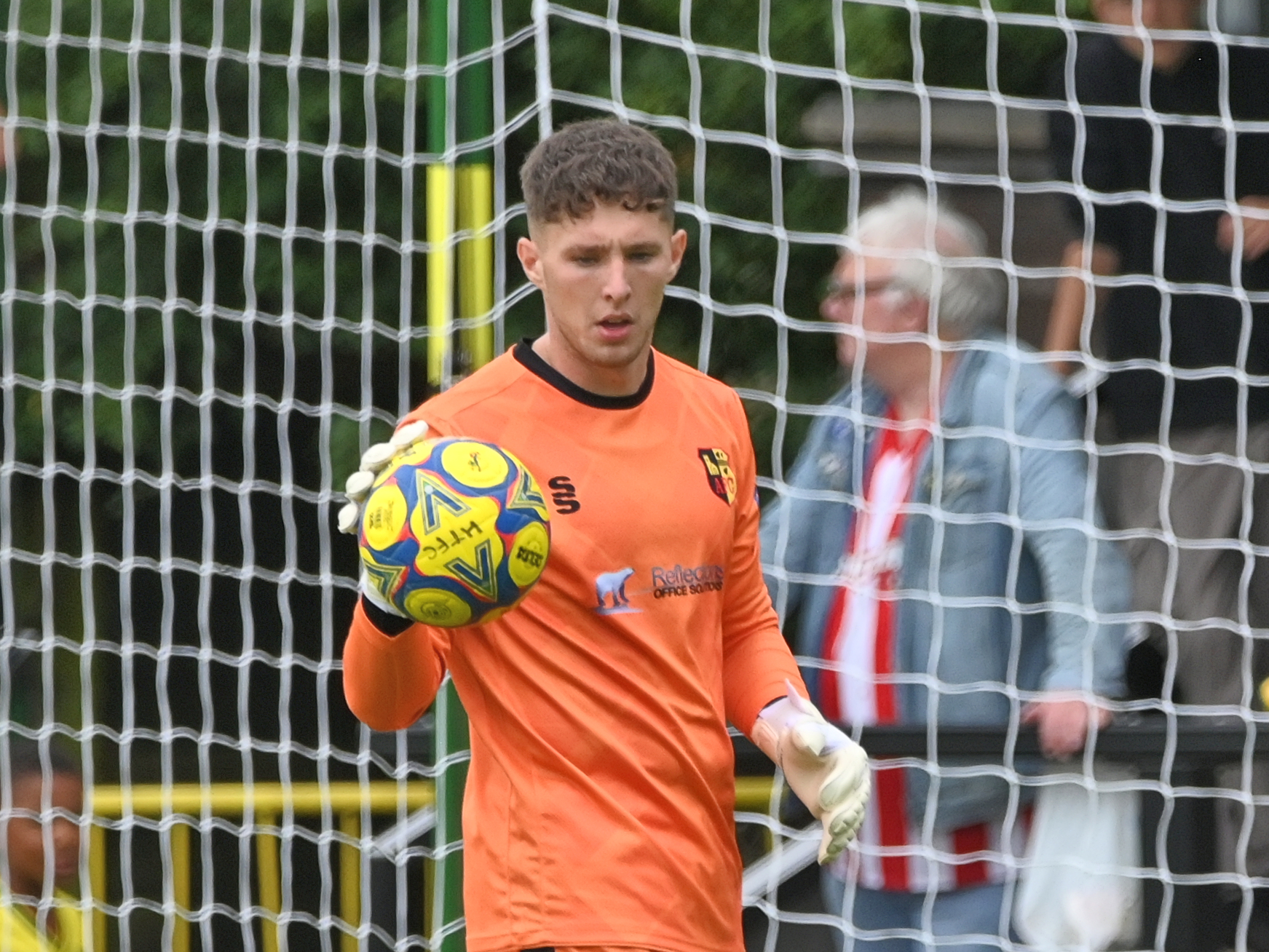 A photo of young keeper Ronnie Hollingshead, in action for loan club Alvechurch, wearing an orange goalkeeper shirt