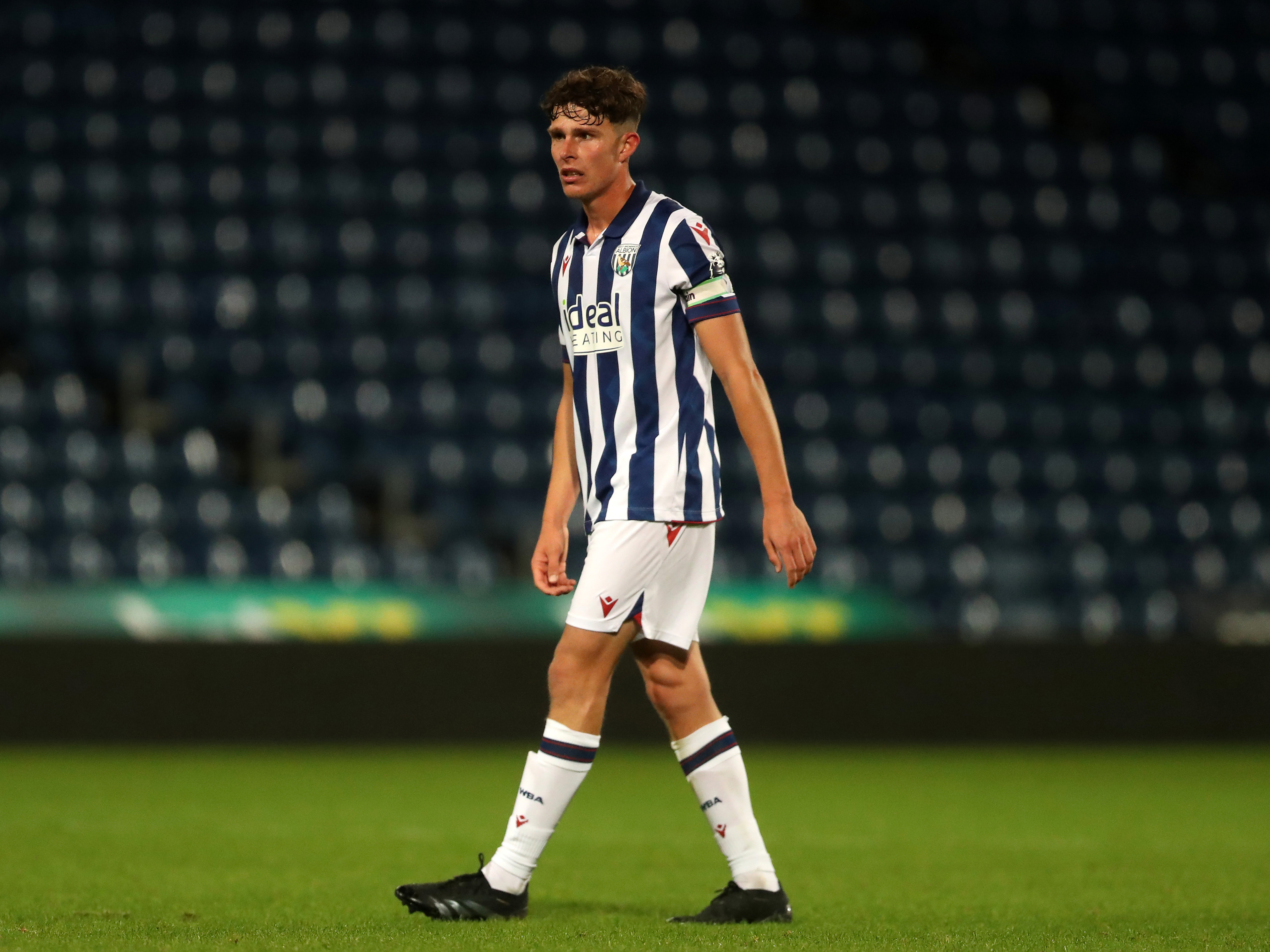 A photo of Matt Richards in the 2024/25 home kit in action n at The Hawthorns