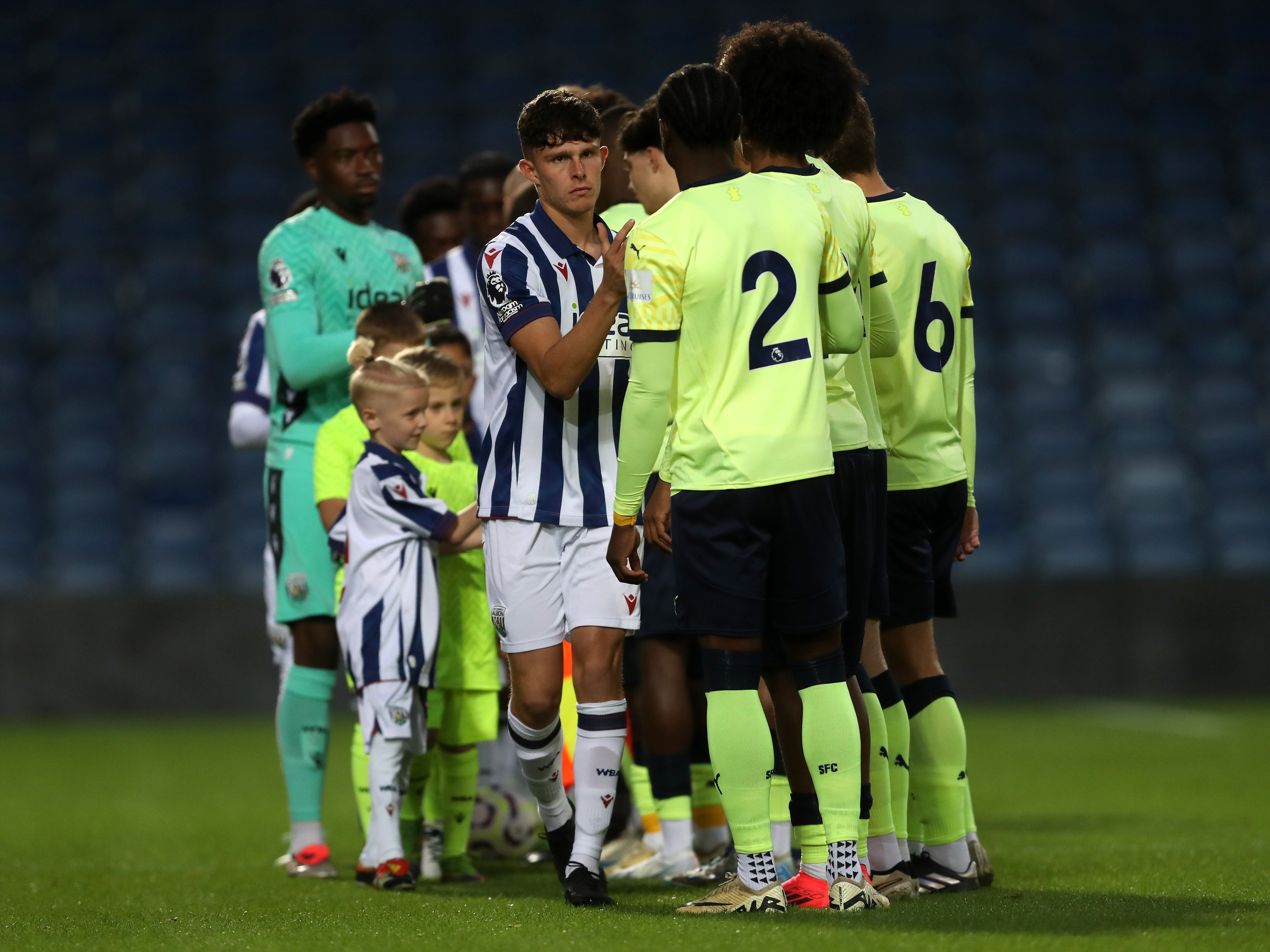 A photo of Matt Richards shaking hands with opponents before a PL2 game at The Hawthorns