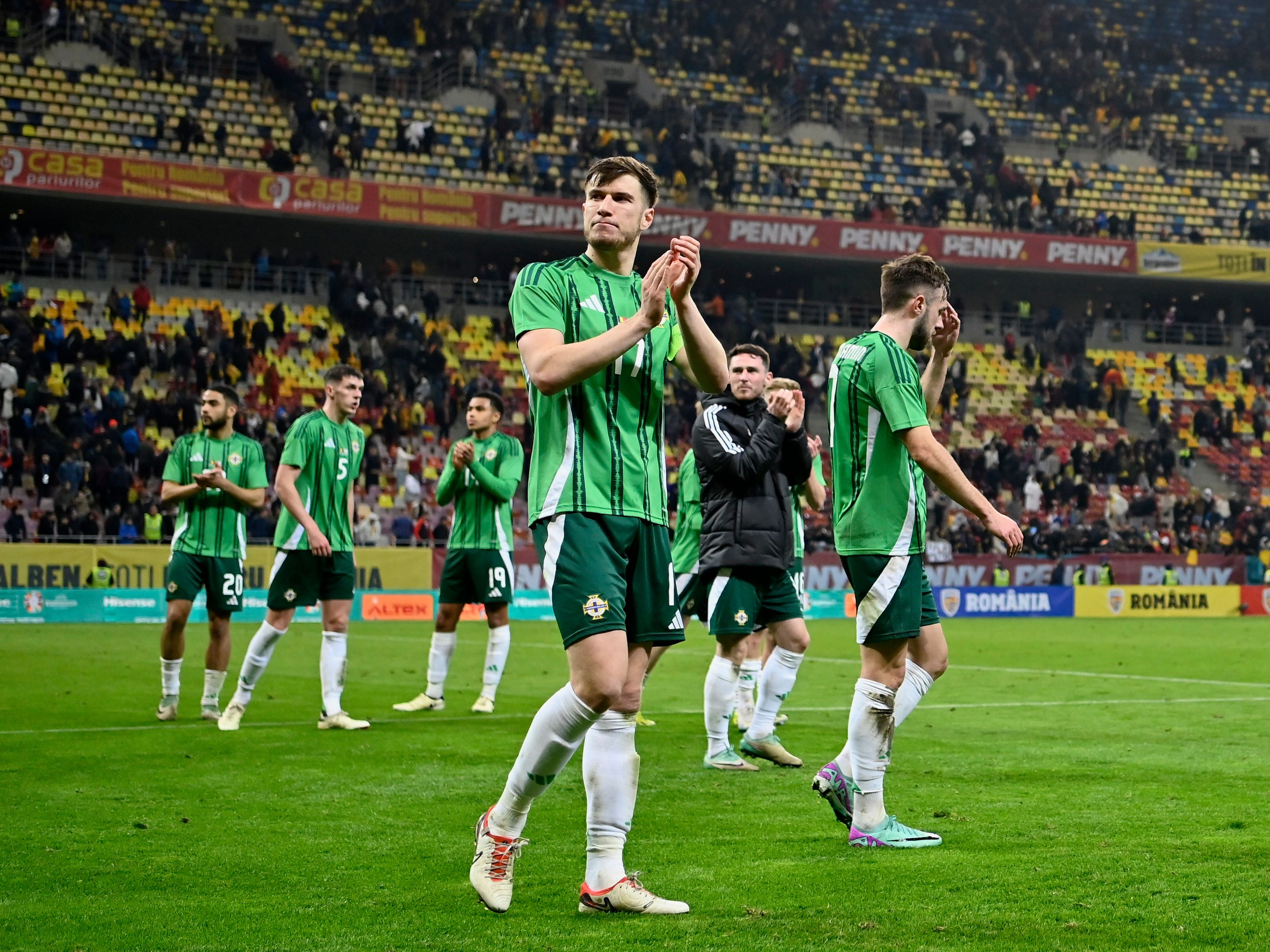 Paddy McNair applauds Northern Ireland supporters while wearing his nation's home shirt 