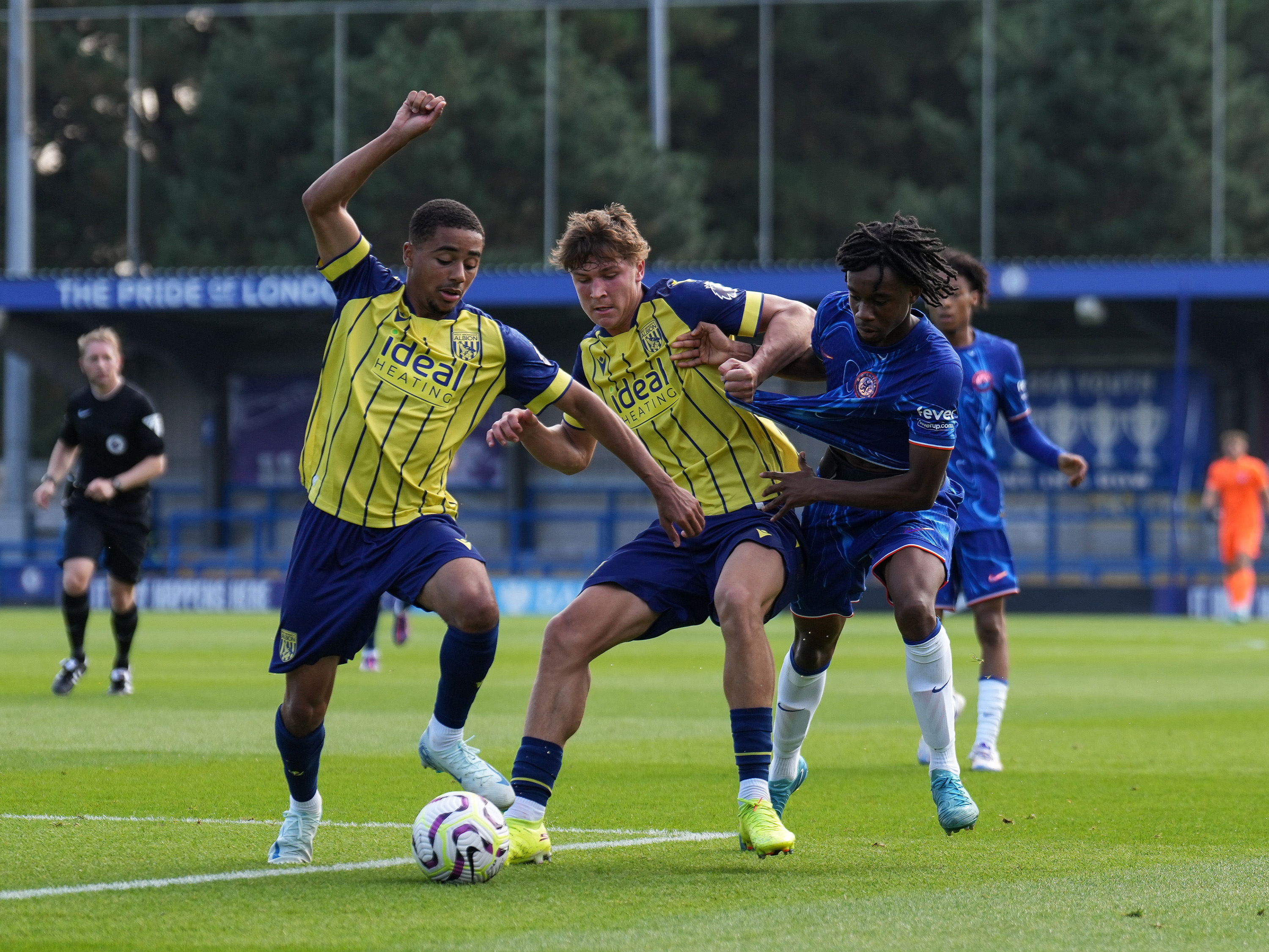 A photo of youngsters Cole Deeming and Drago Nelson in the 2024/25 yellow and blue away kit playing in a PL2 match v Chelsea in blue