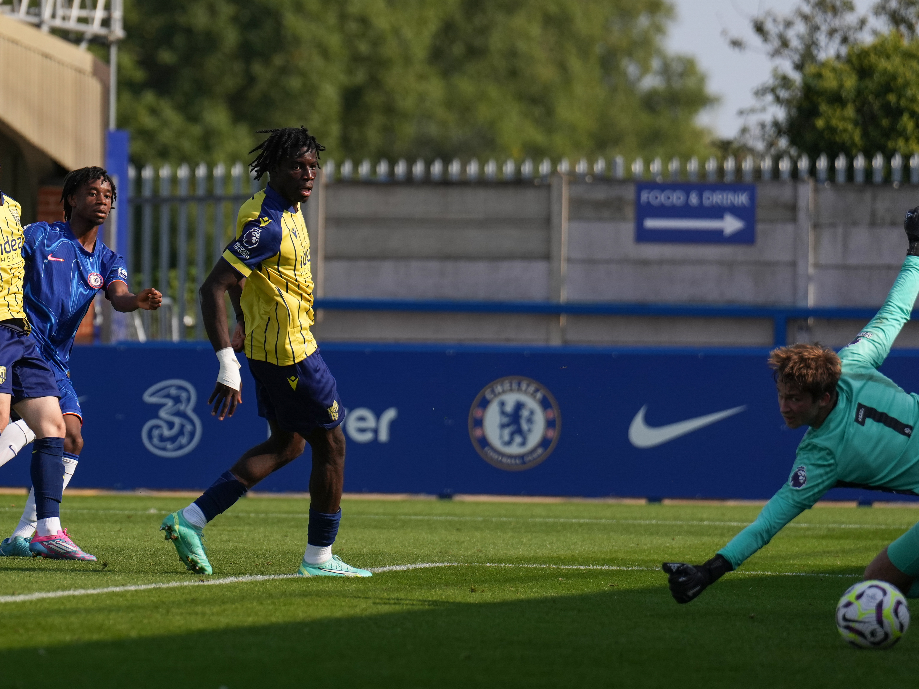 A photo of Albion's PL2 team, in the yellow and blue 2024/25 away kit, in action against Chelsea