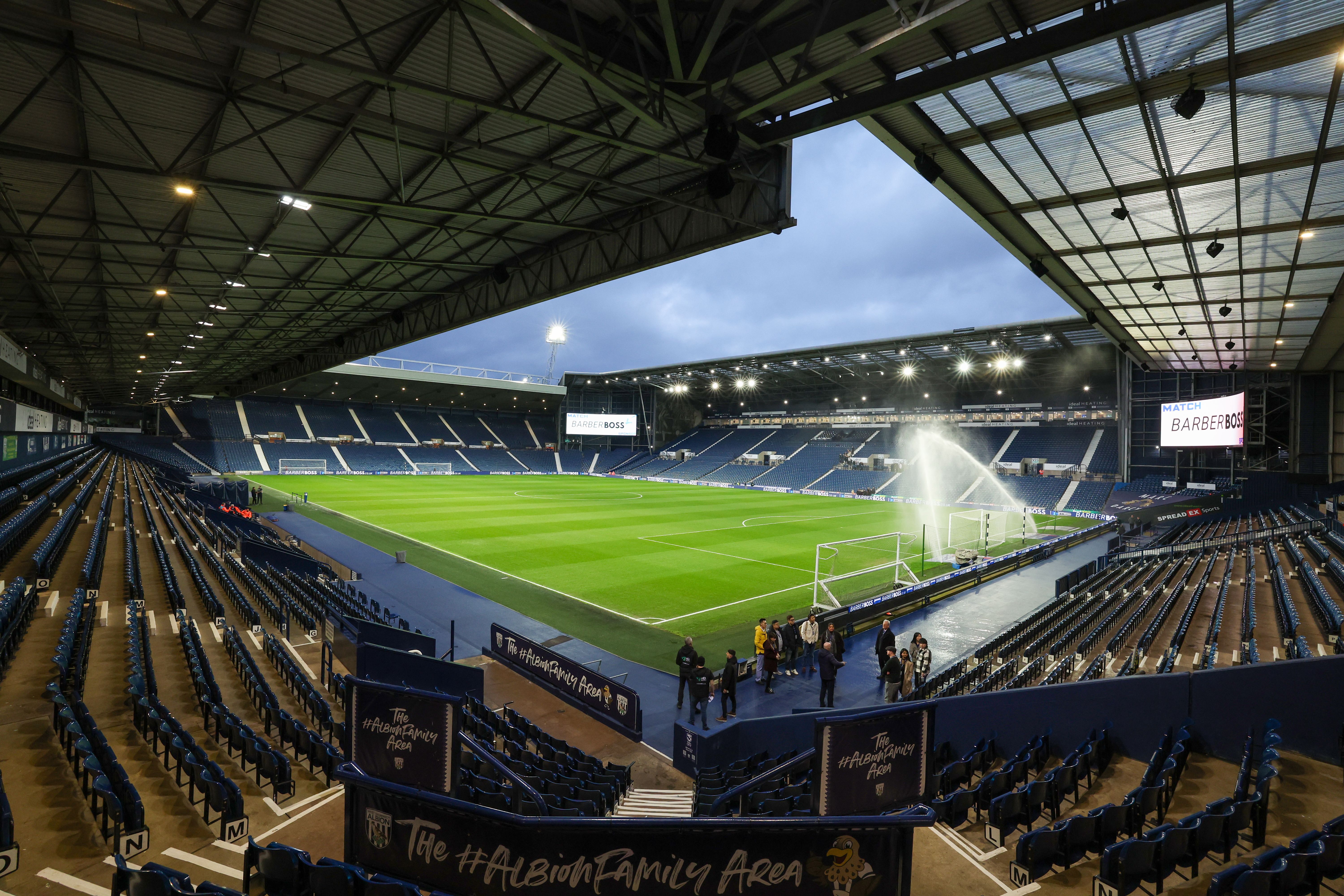 A general view of The Hawthorns empty at night with a sprinkler spraying water on the pitch 