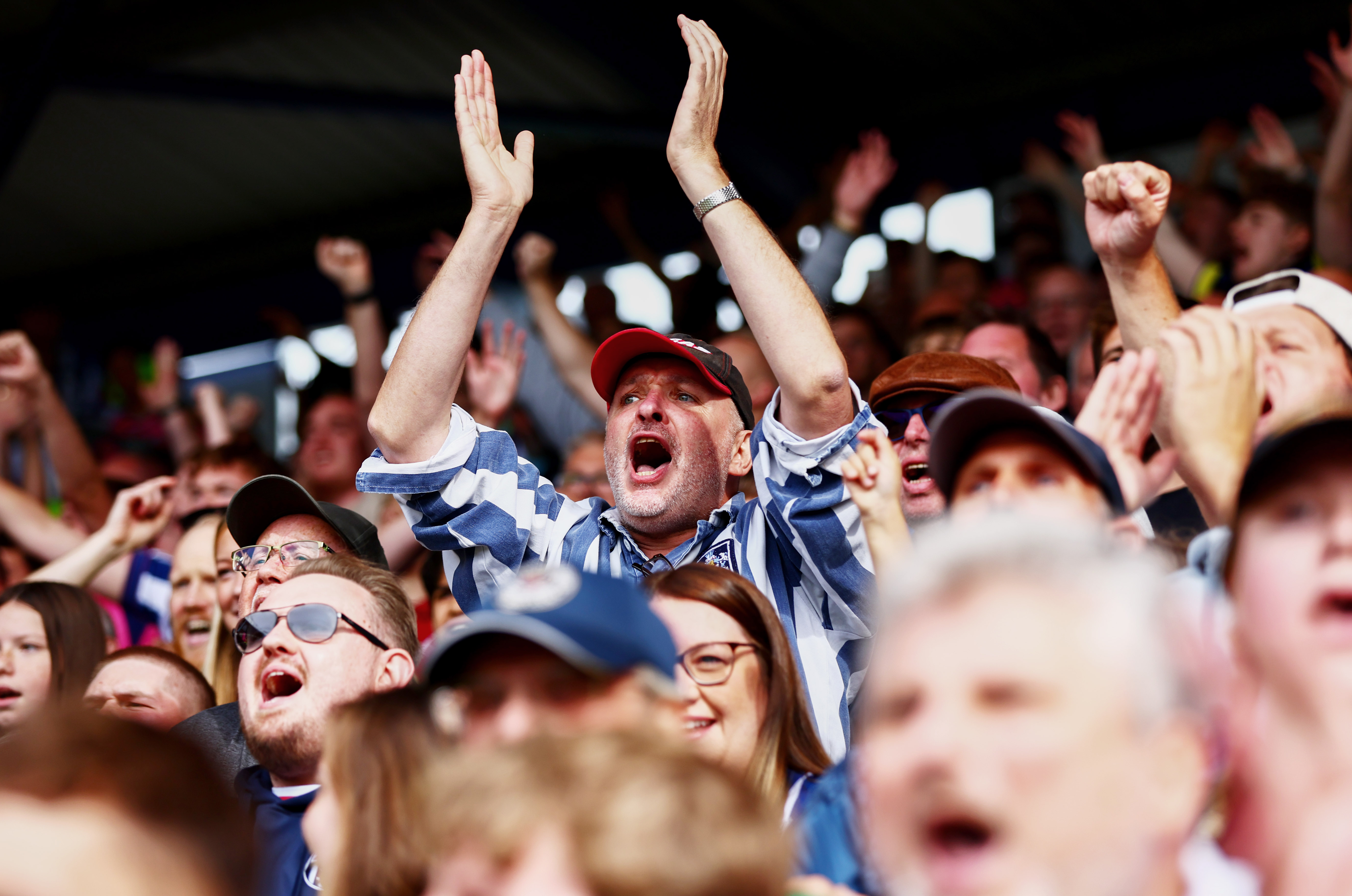 A general view of an Albion fan cheering at a game 