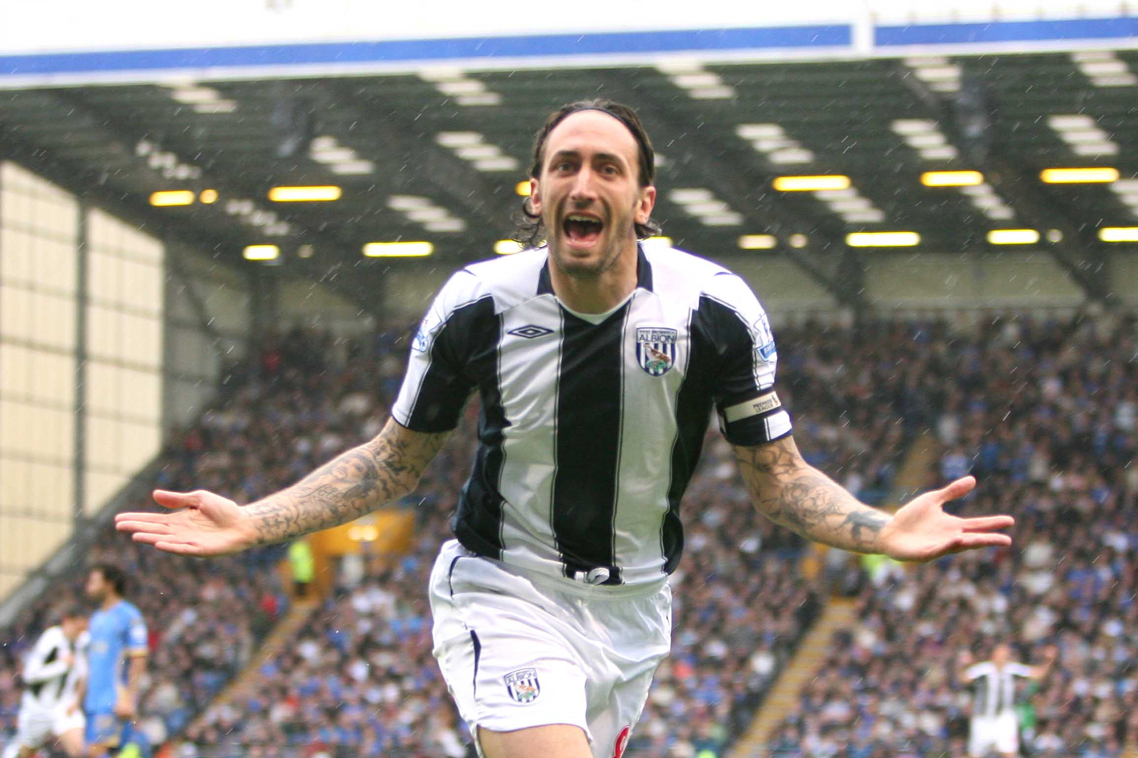 Jonathan Greening celebrates scoring against Portsmouth at Fratton Park in April 2009 wearing the home kit 