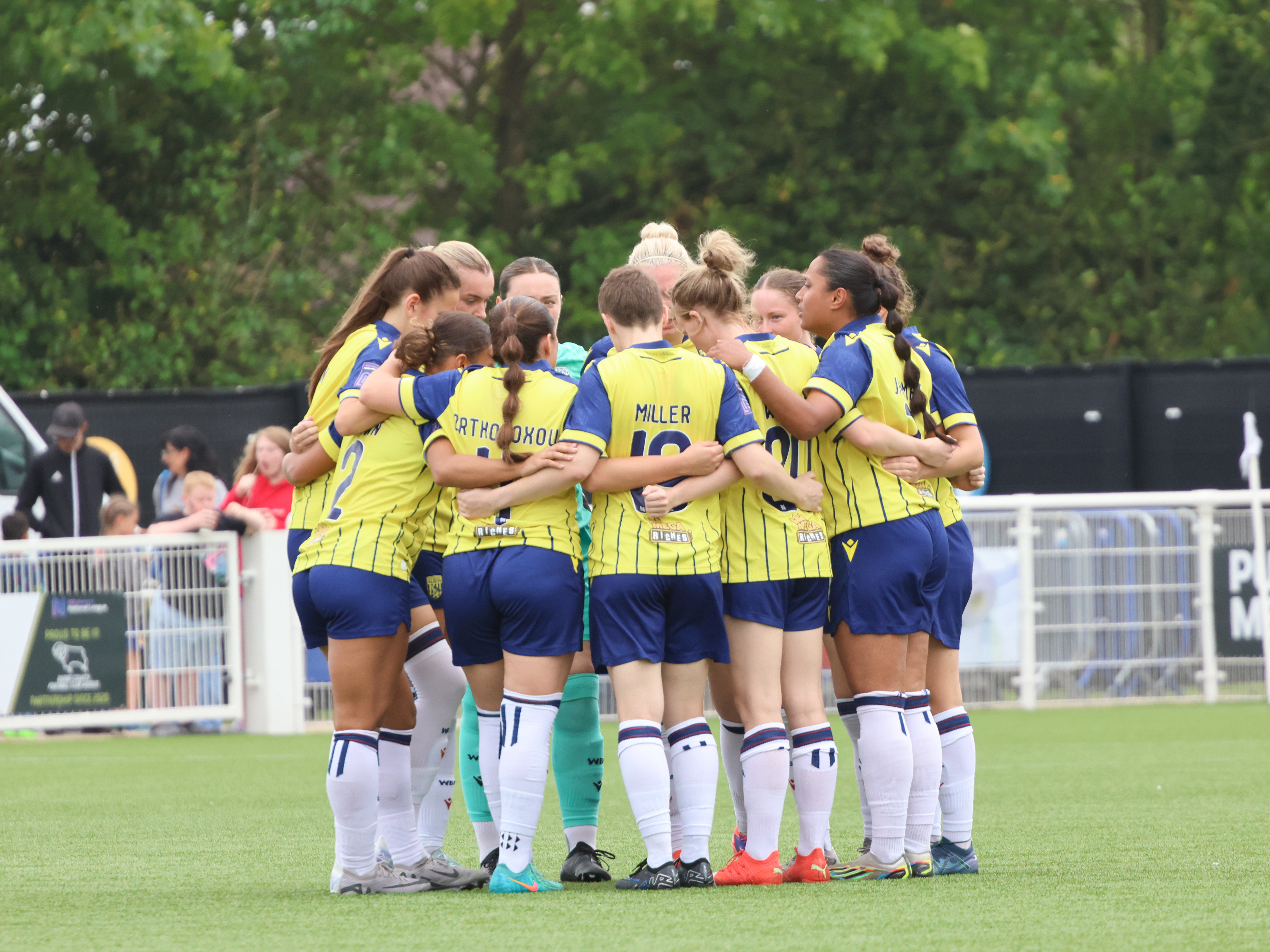 An image of Albion Women in a team huddle ahead of their game at Derby County