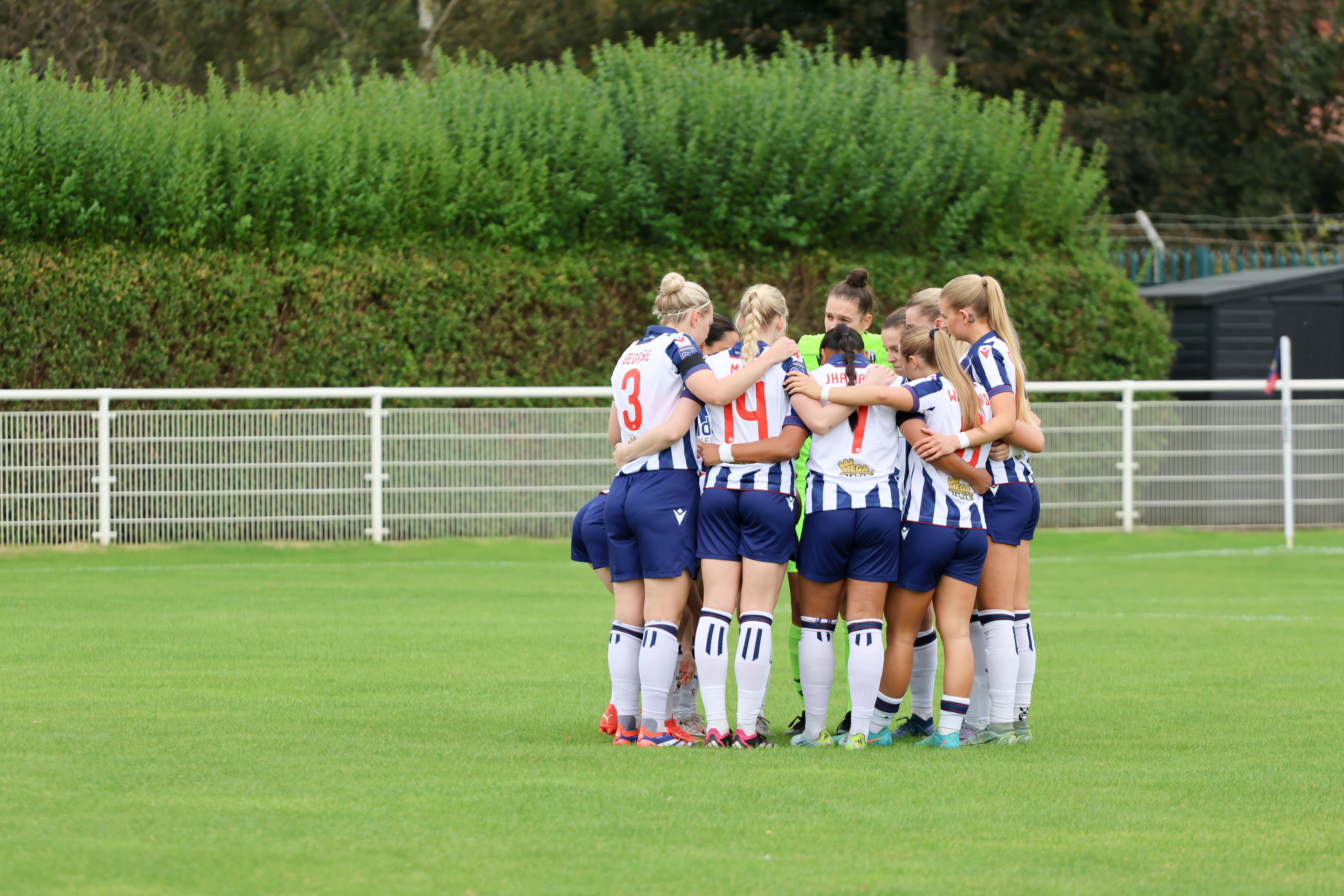 Albion Women in a team huddle.