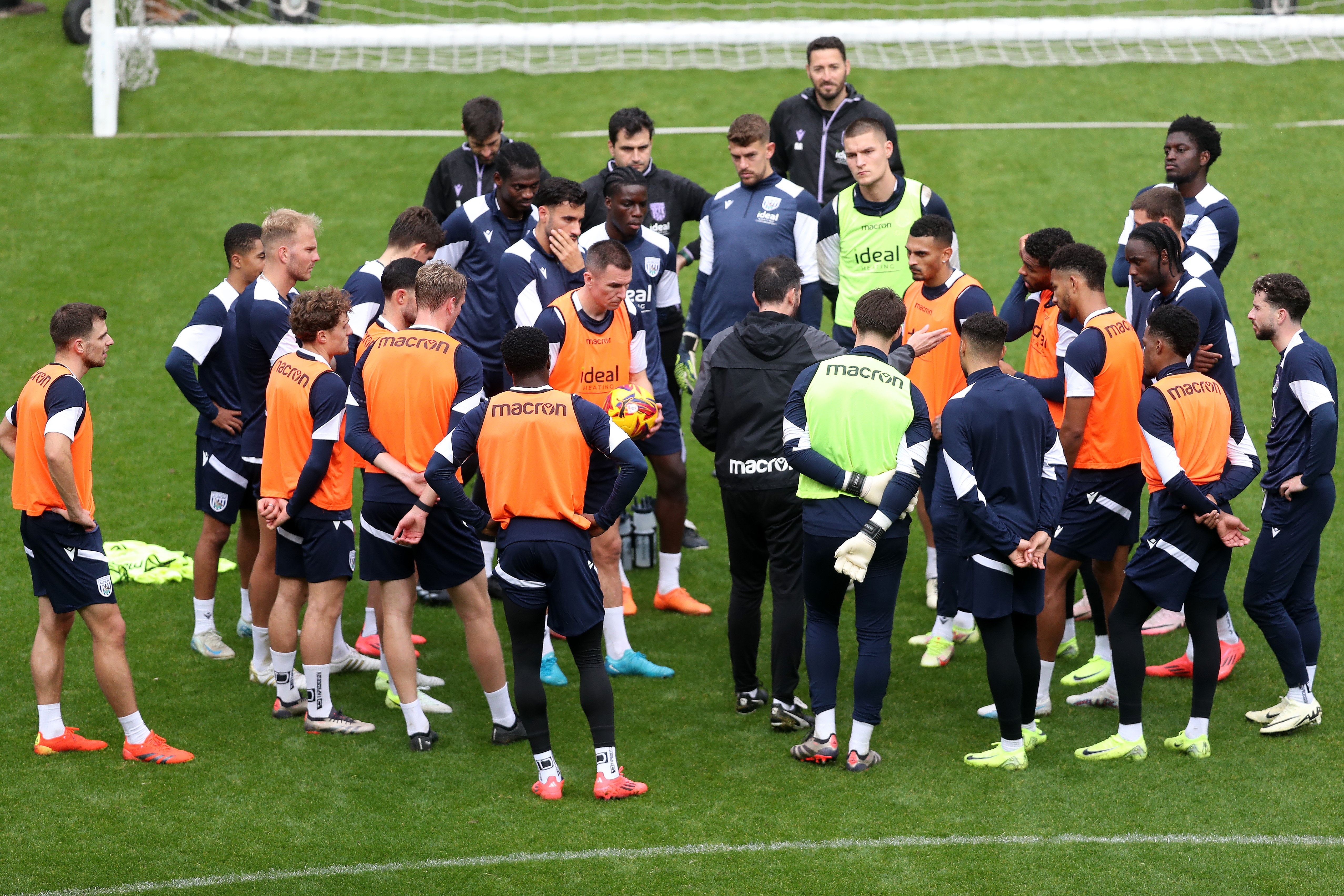 Carlos Corberán delivering instructions to his players on the pitch at The Hawthorns during a session 