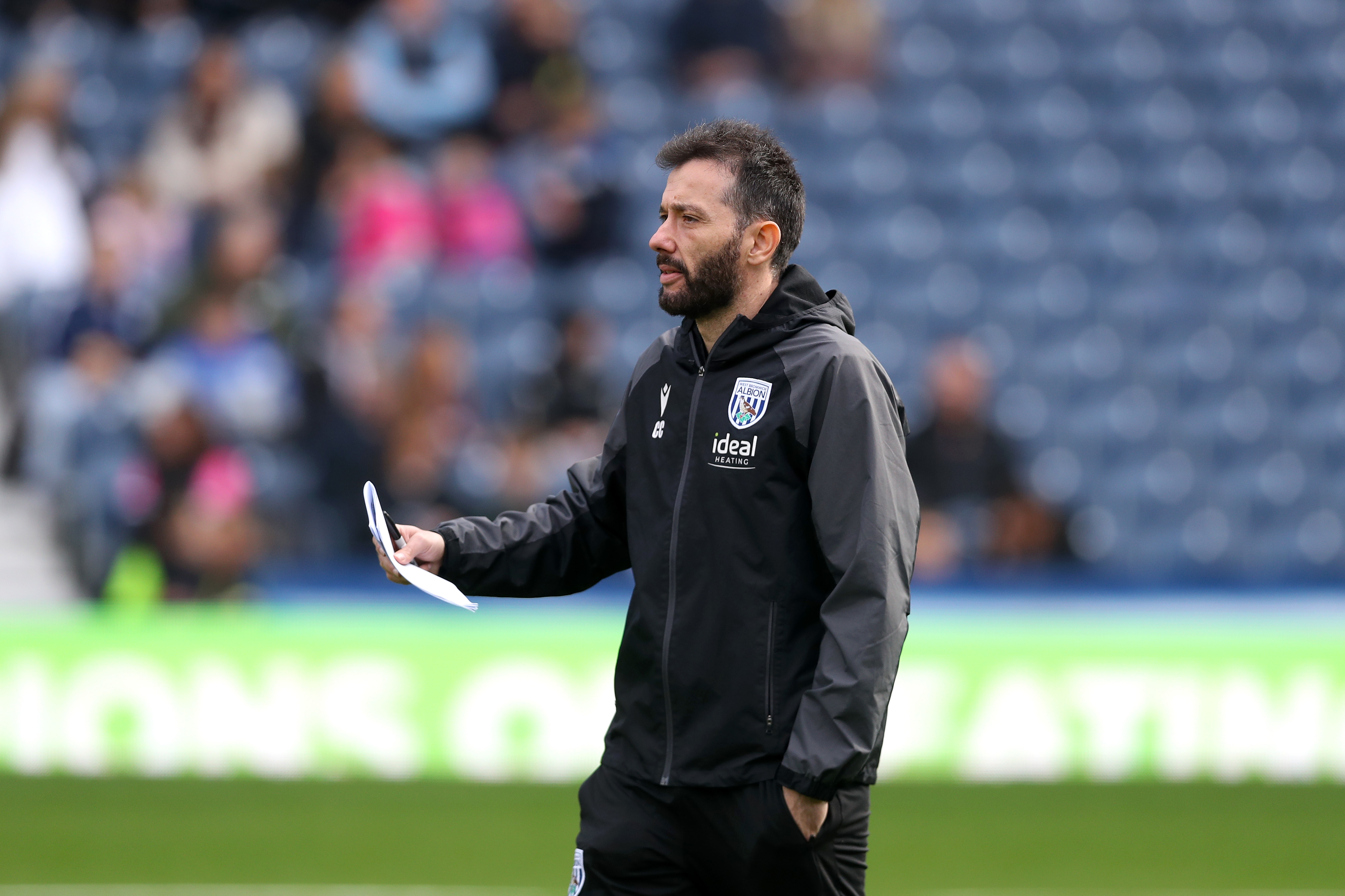 Carlos Corberán with a piece of paper in his hand during a training session at The Hawthorns 