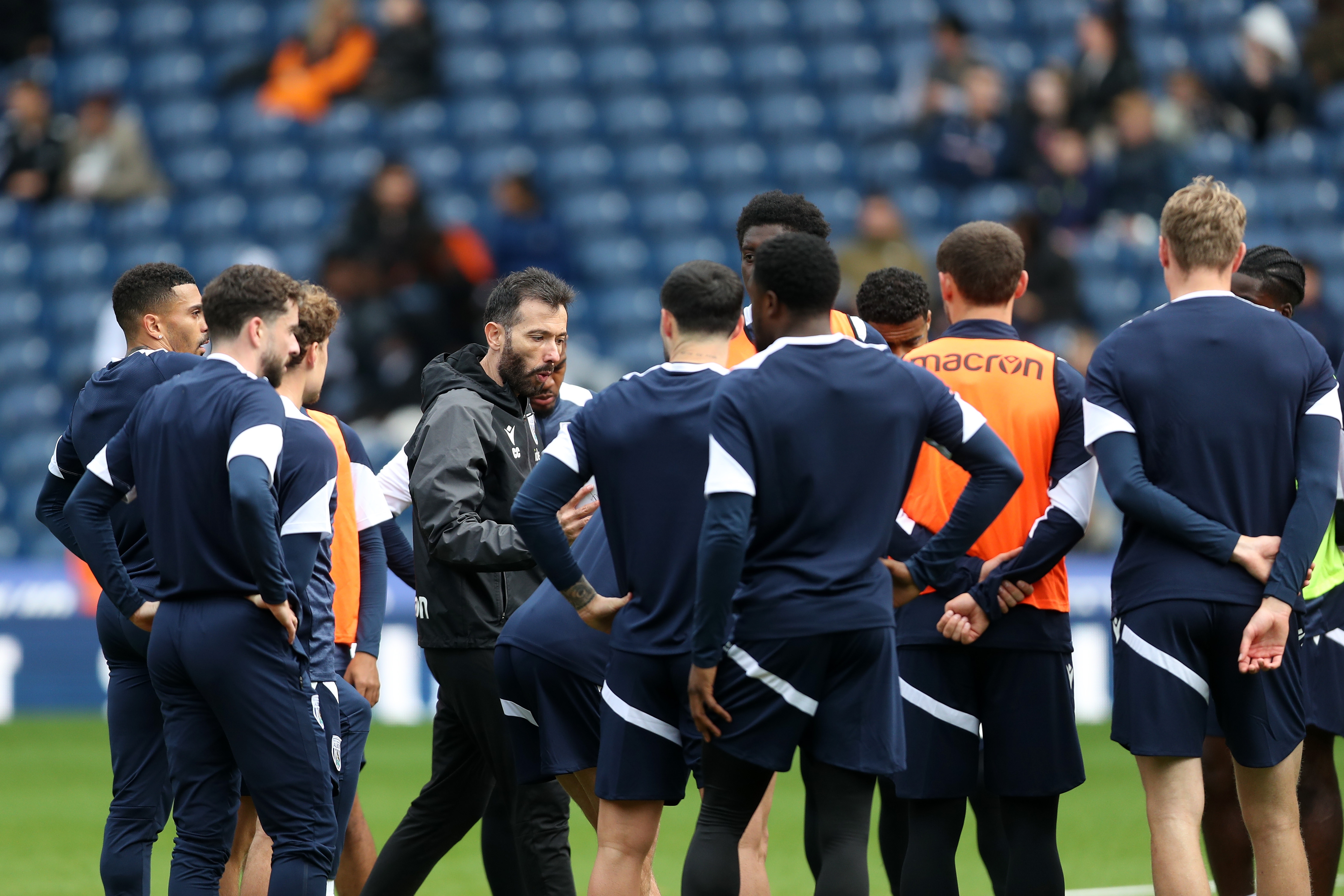 Carlos Corberán delivering instructions to his players on the pitch at The Hawthorns during a session 