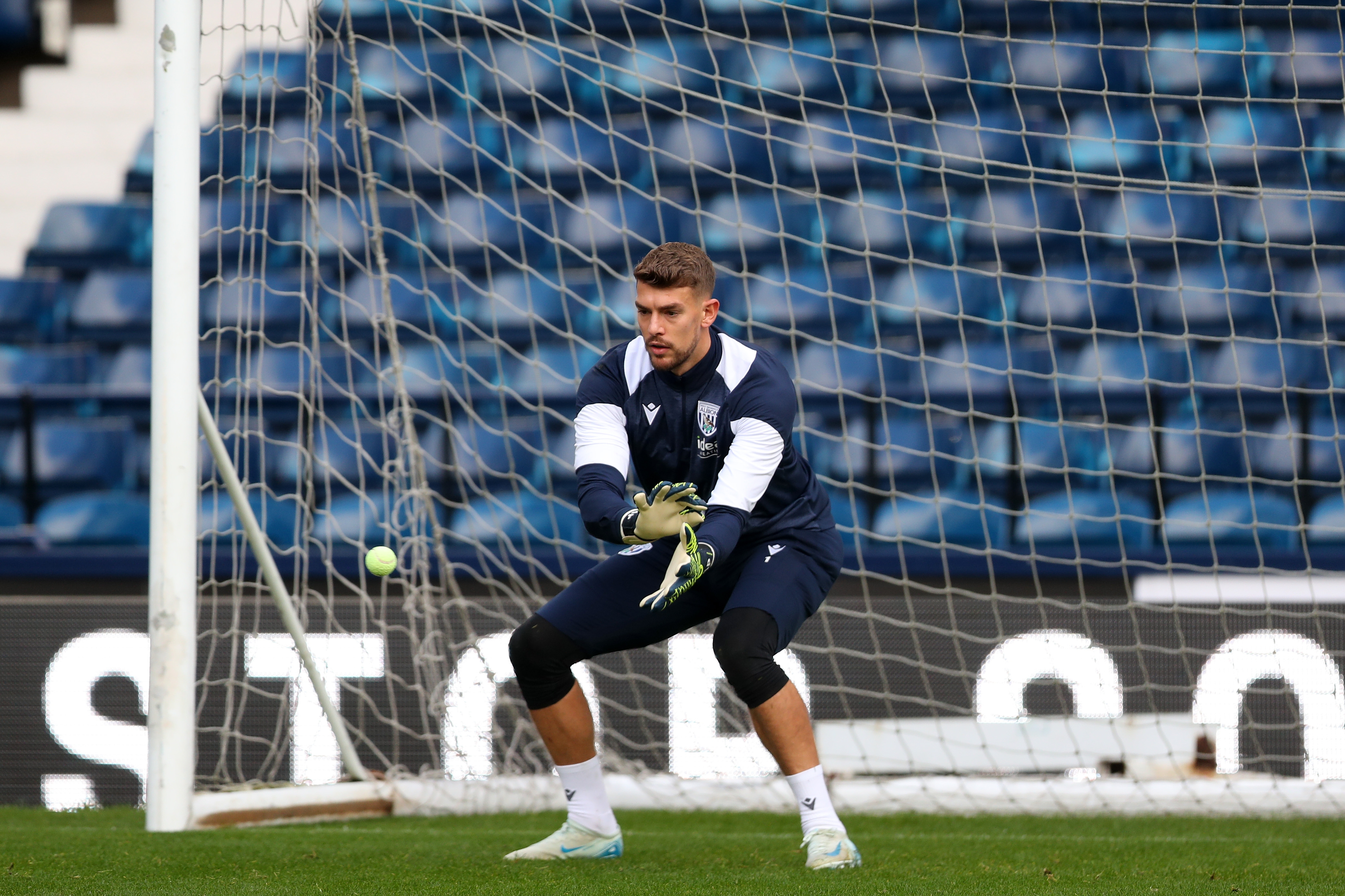 Alex Palmer catching a small ball during a training session at The Hawthorns 