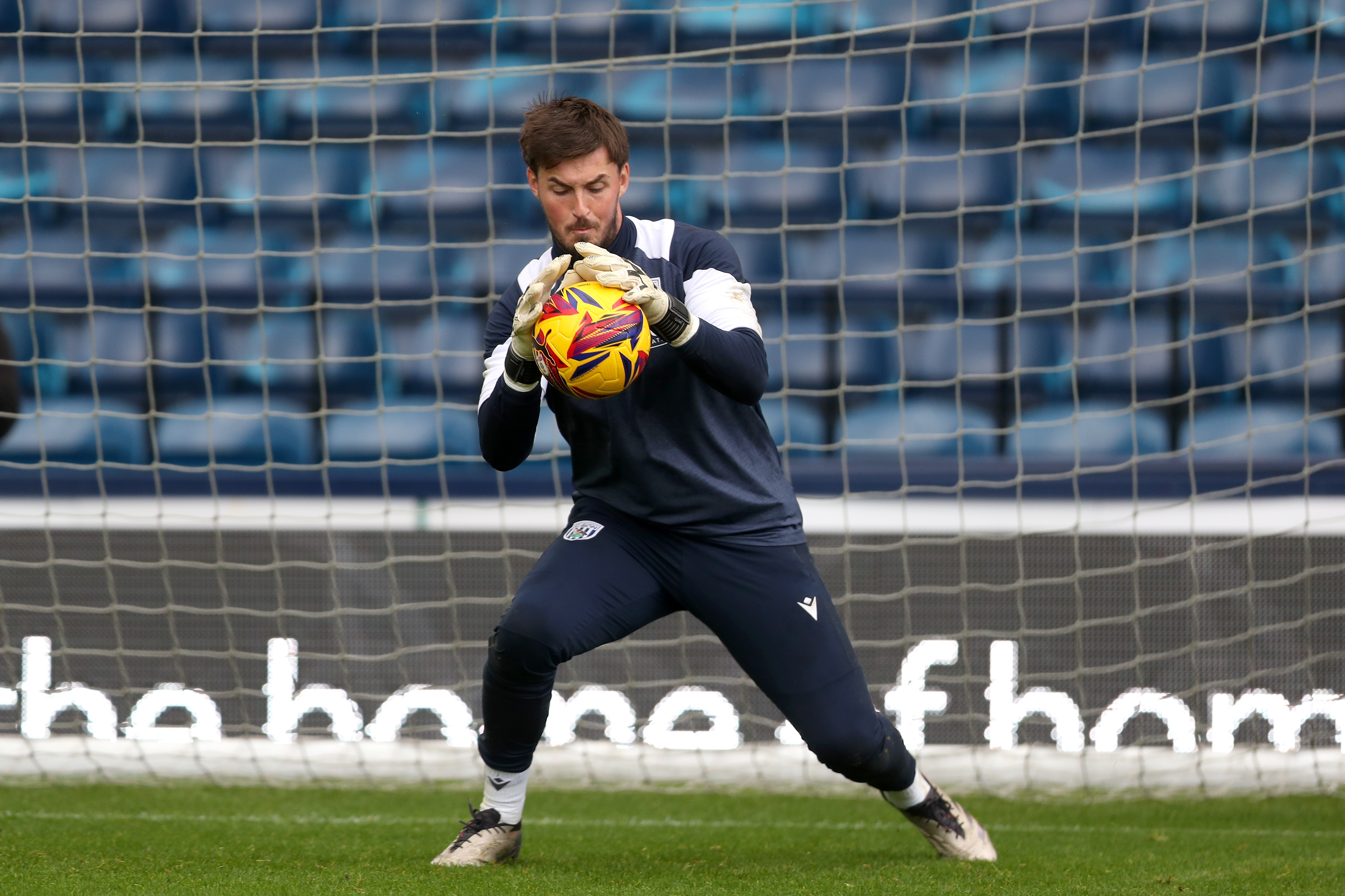 Joe Wildsmith catching a ball during a training session at The Hawthorns