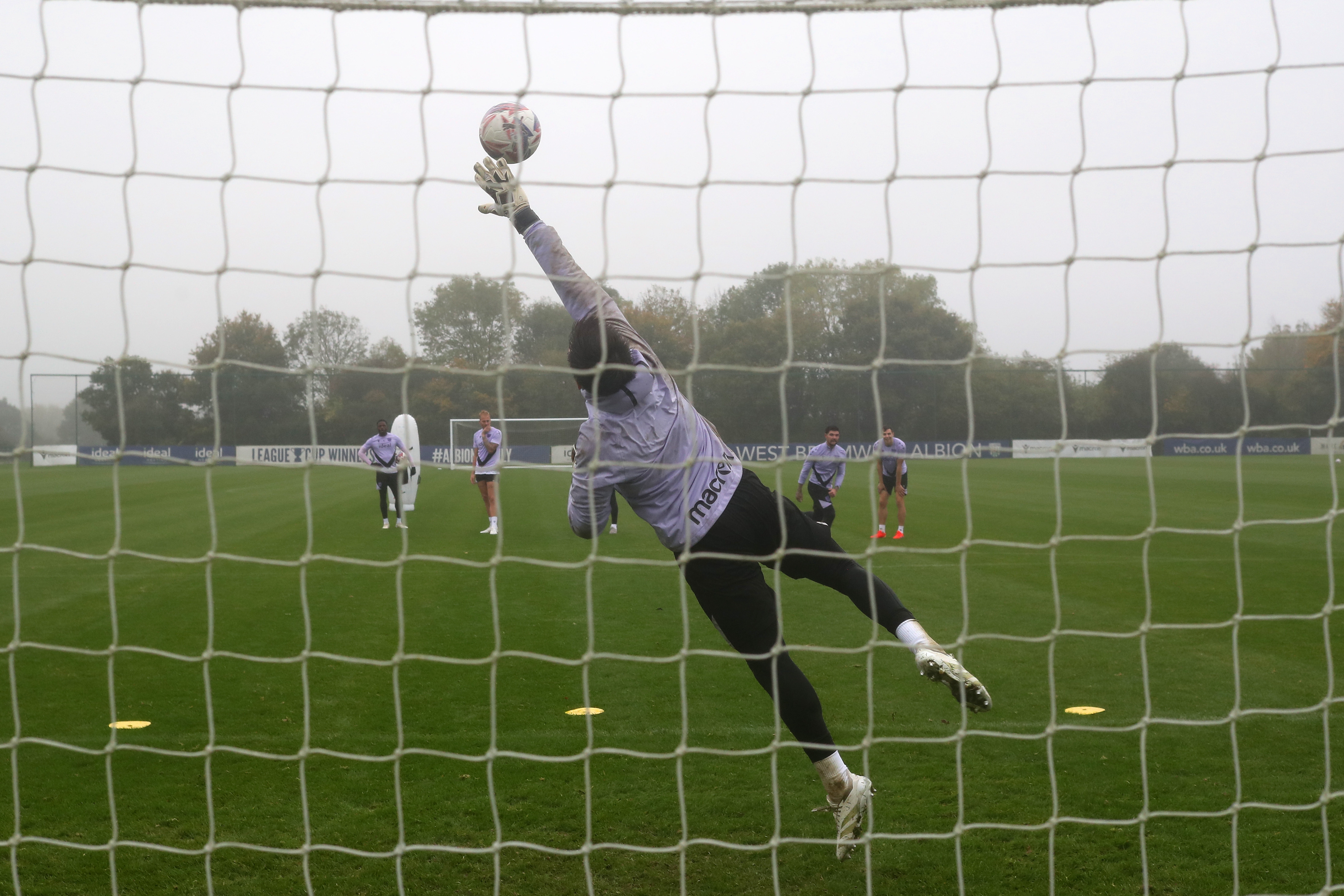 Alex Palmer making a diving save during training 