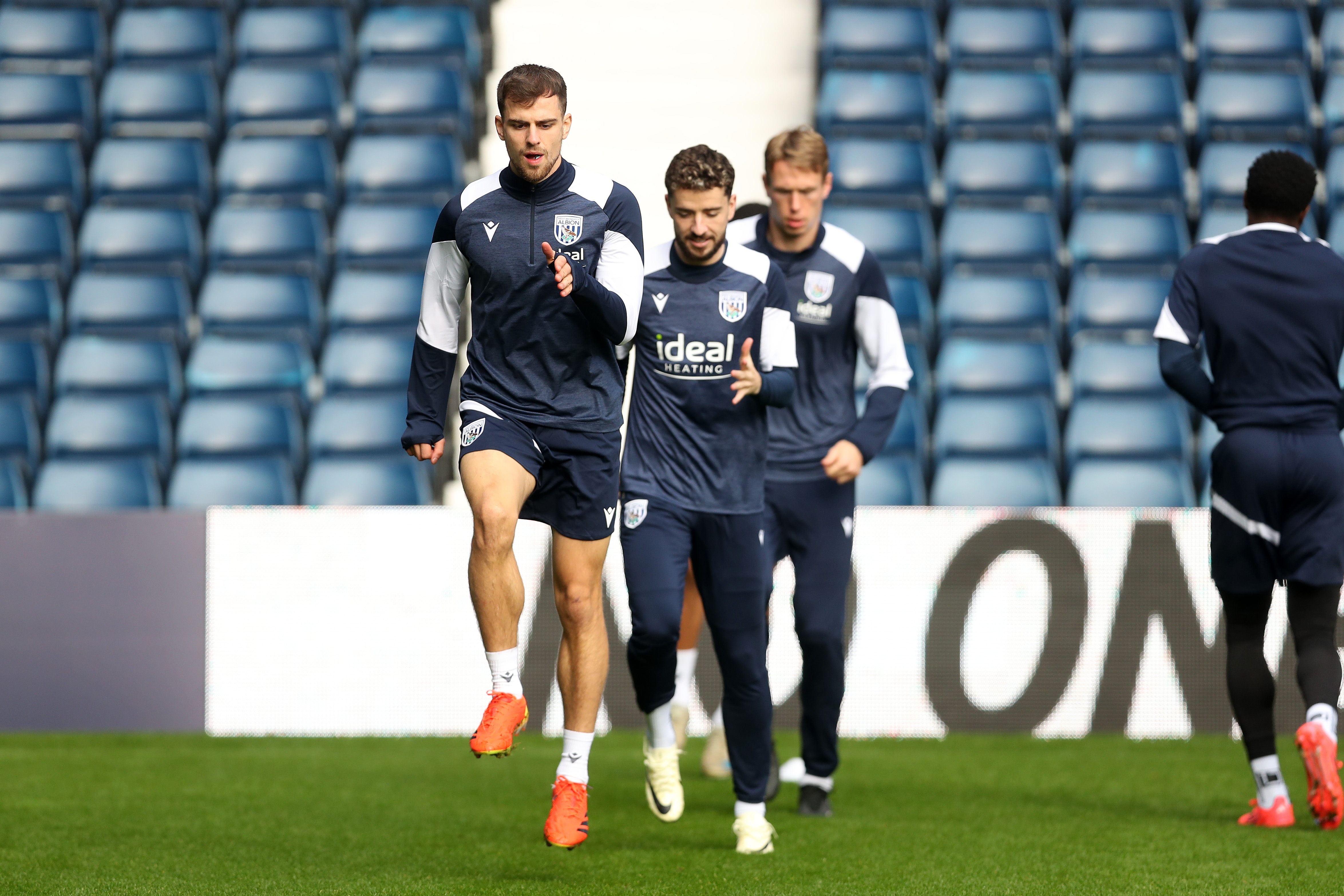 Several Albion players warming up before a training session at The Hawthorns