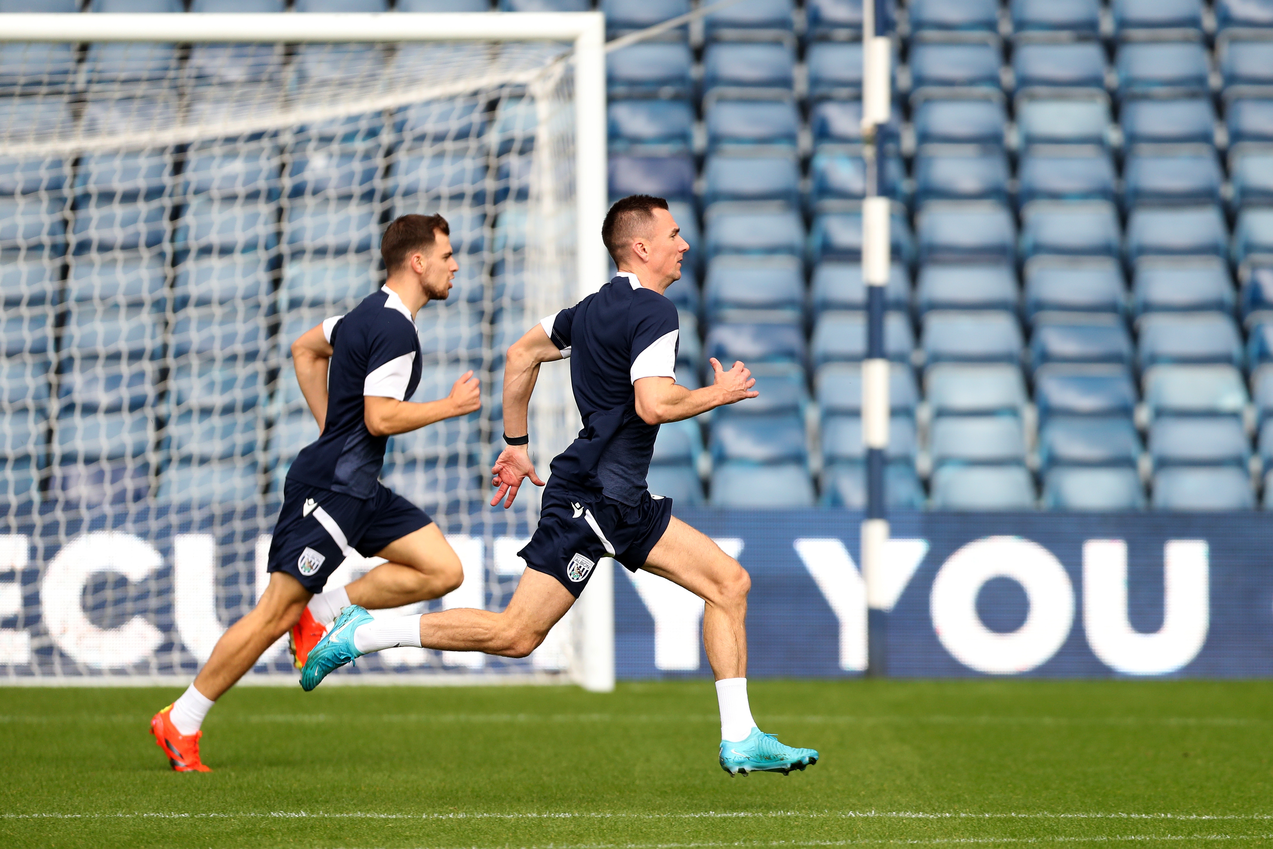 Several Albion players warming up before a training session at The Hawthorns