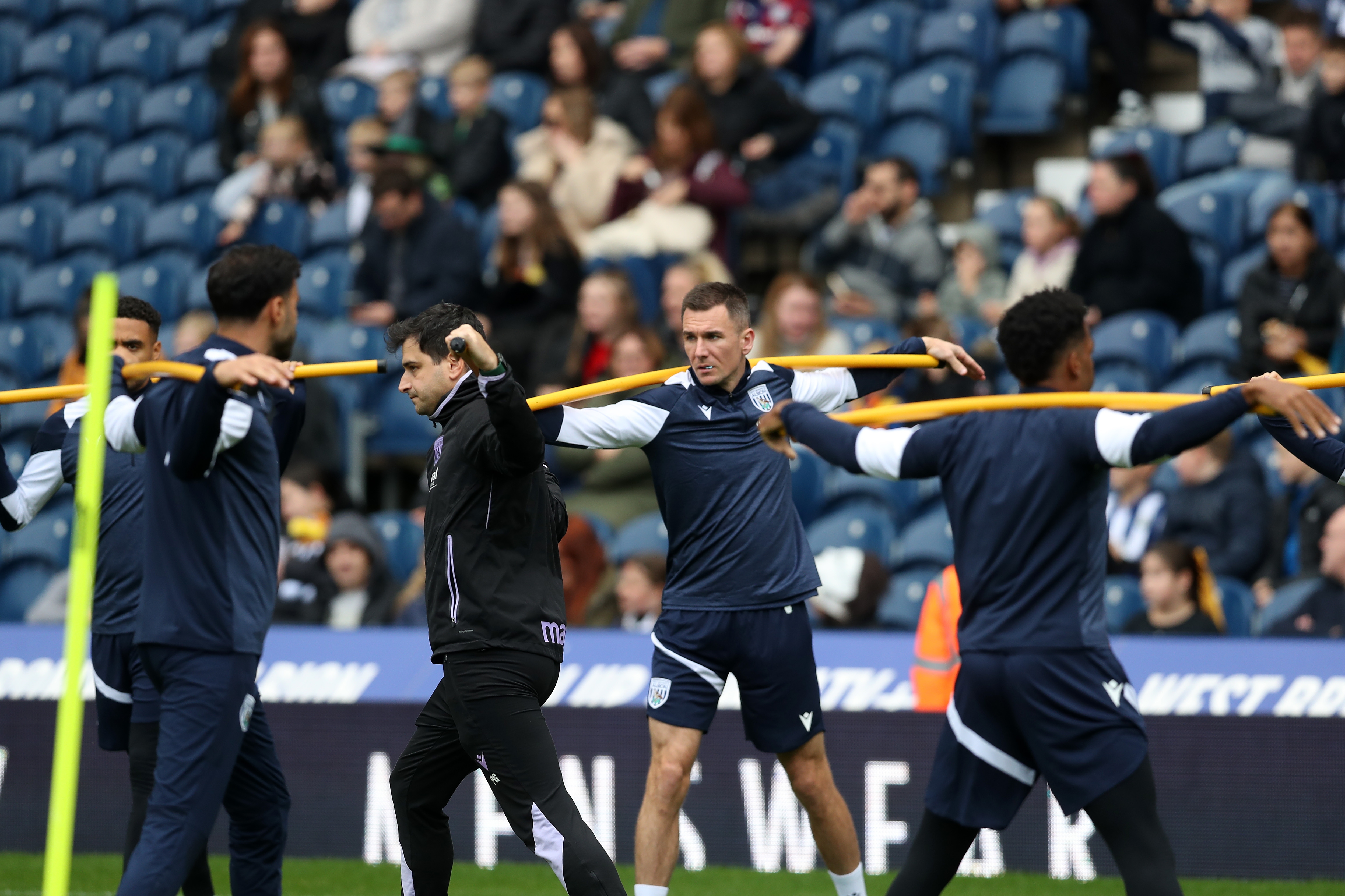 Several Albion players warming up before a training session at The Hawthorns