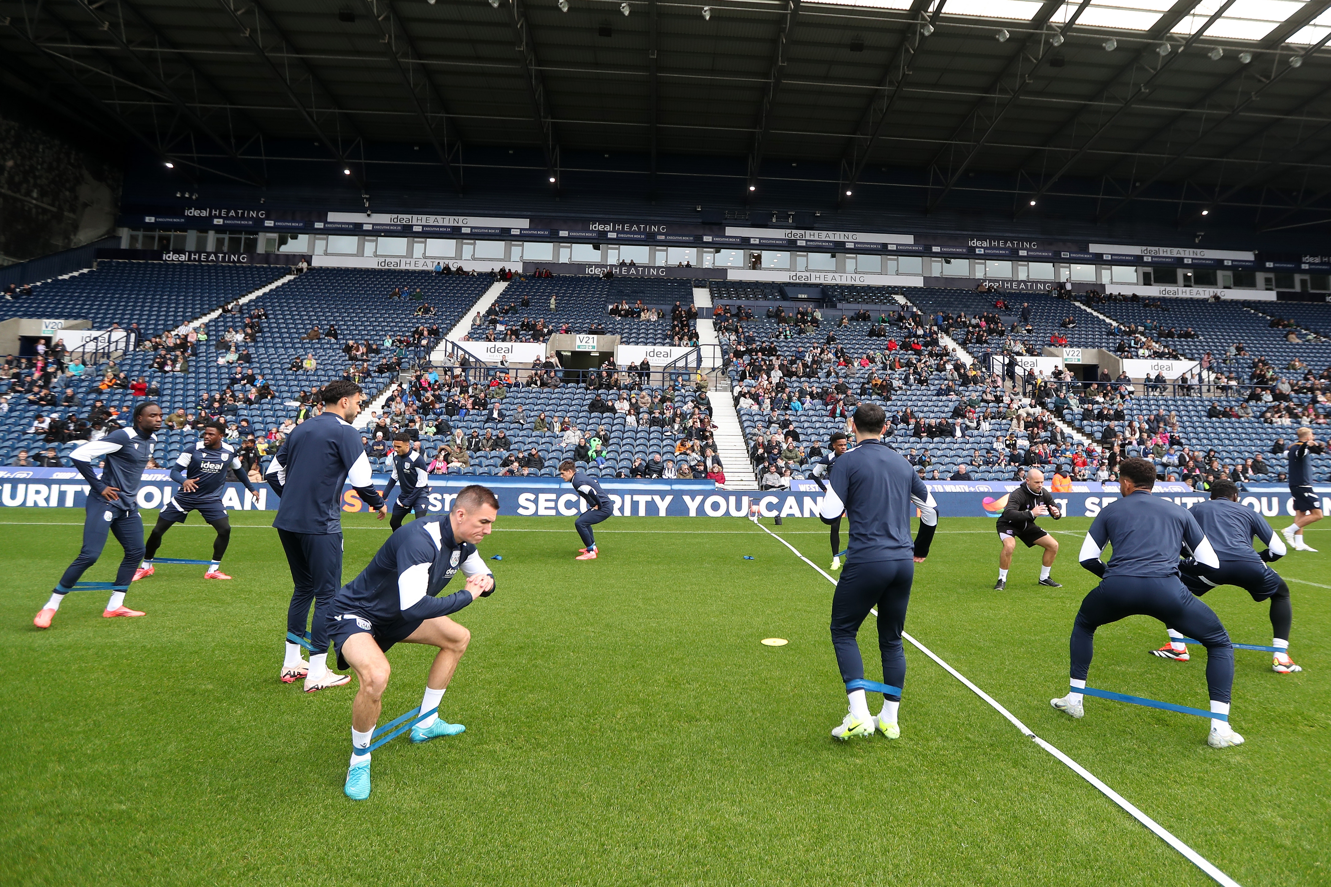 Several Albion players warming up before a training session at The Hawthorns