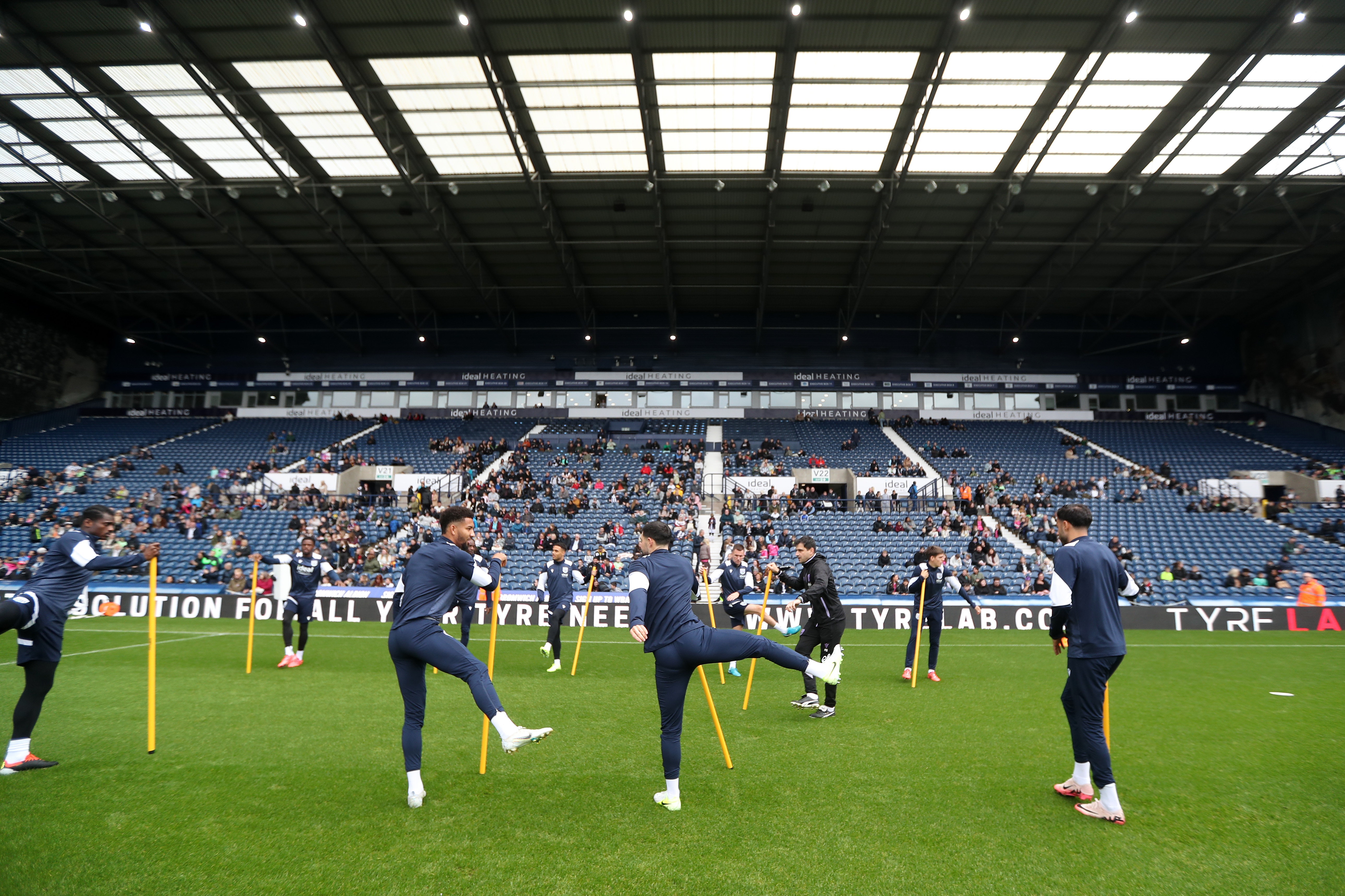 Several Albion players warming up before a training session at The Hawthorns