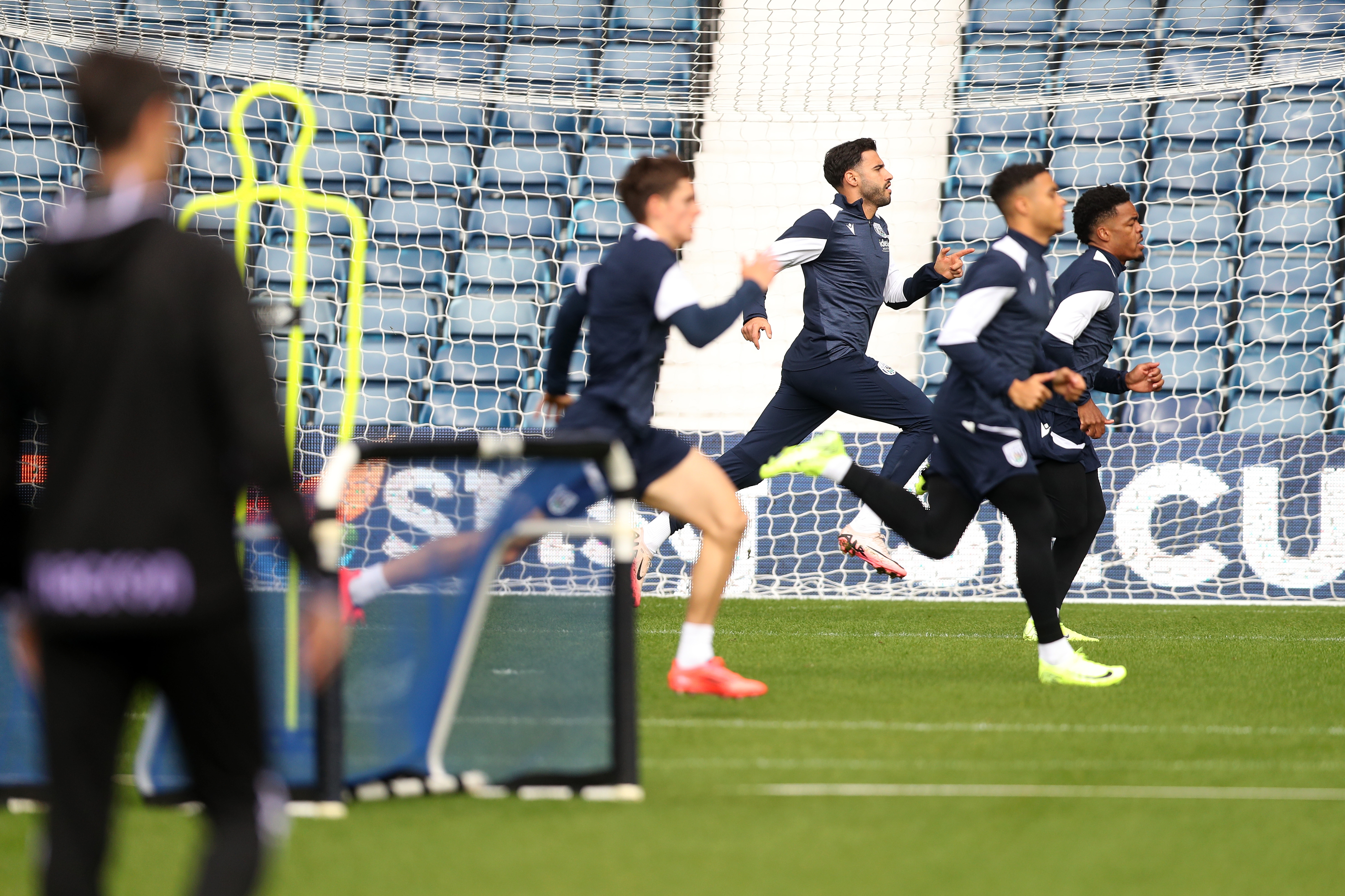 Several Albion players warming up before a training session at The Hawthorns