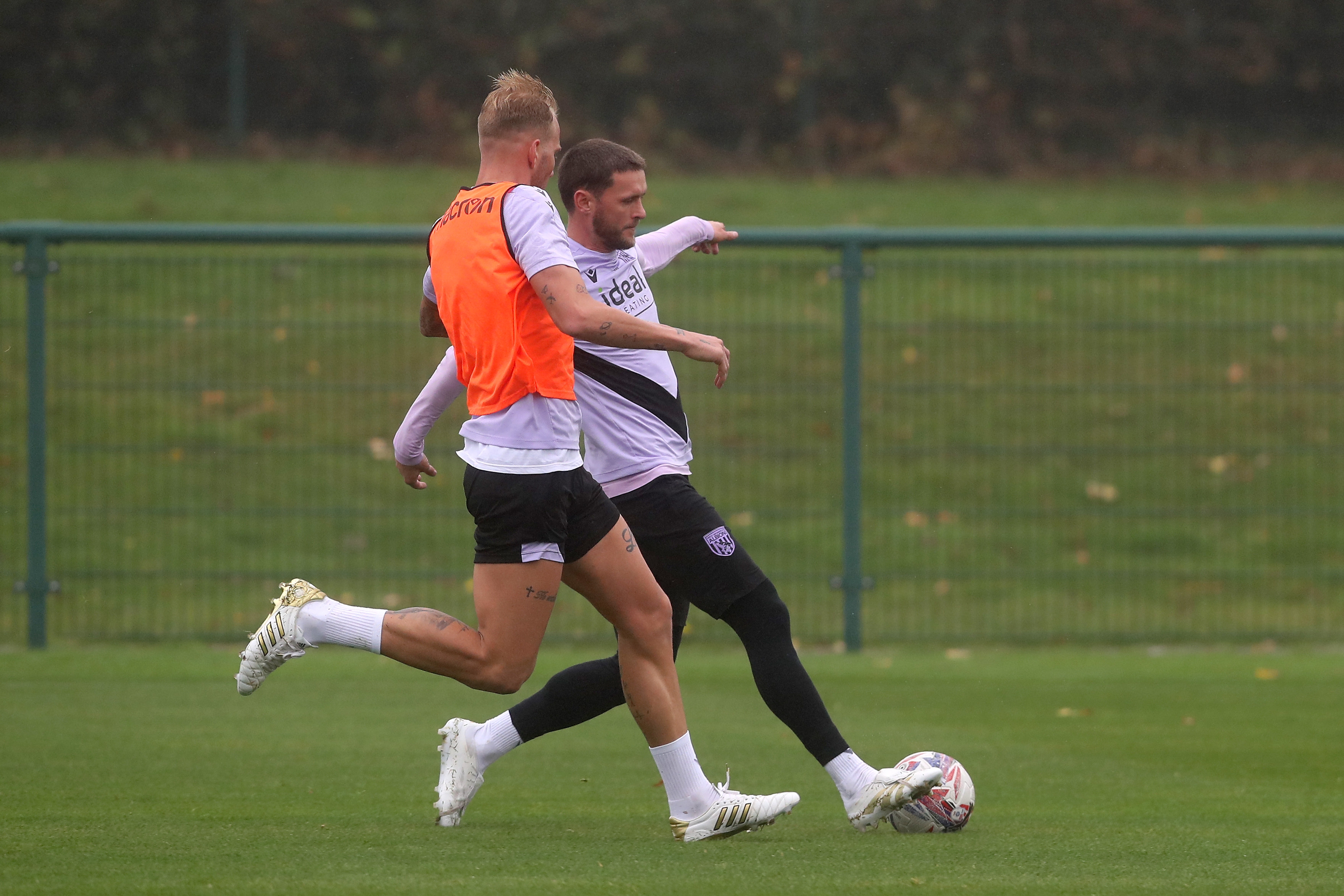 John Swift and Uroš Račić fighting for the ball during training 