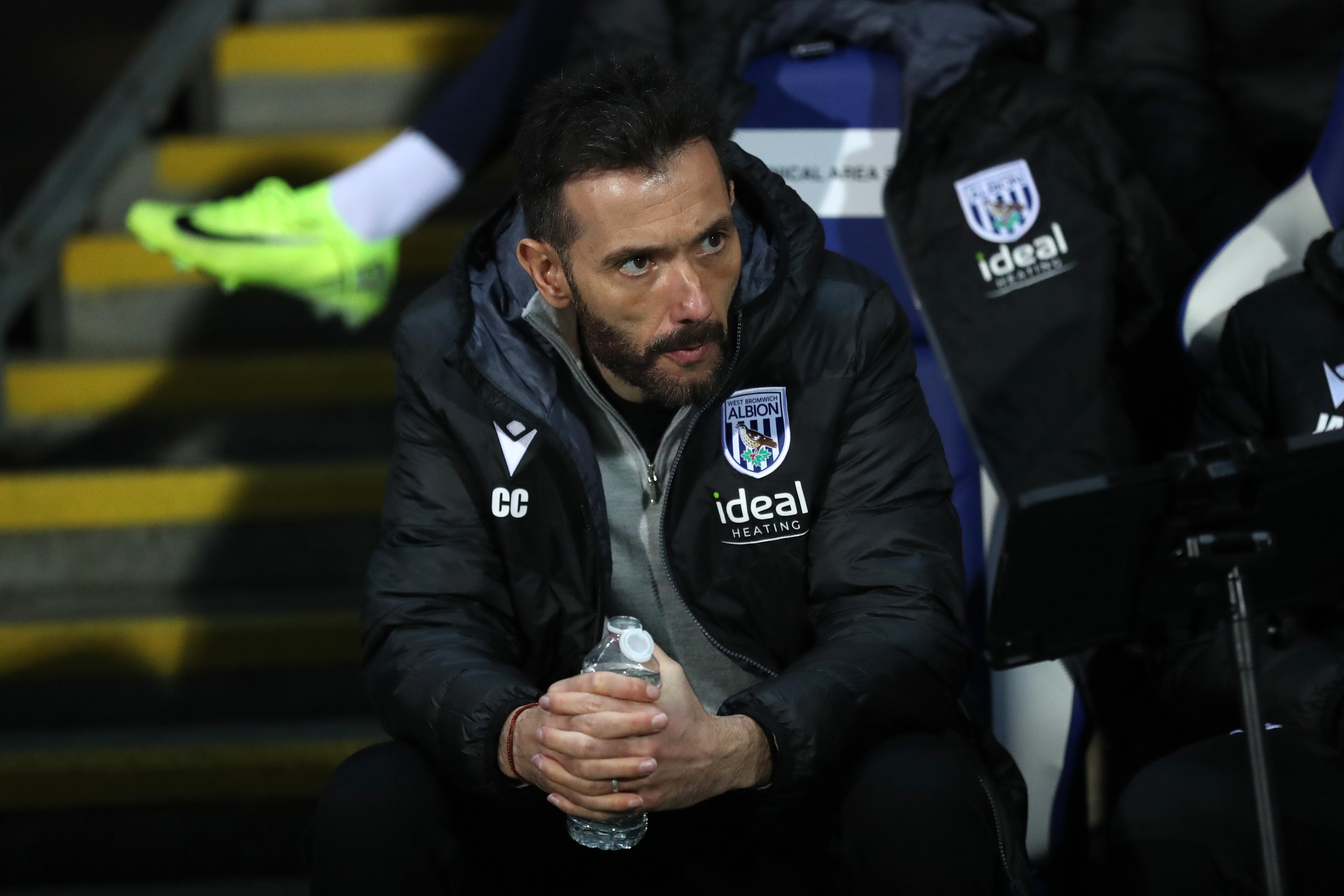 Carlos Corberán sat in the dugout at Blackburn Rovers looking to his left 