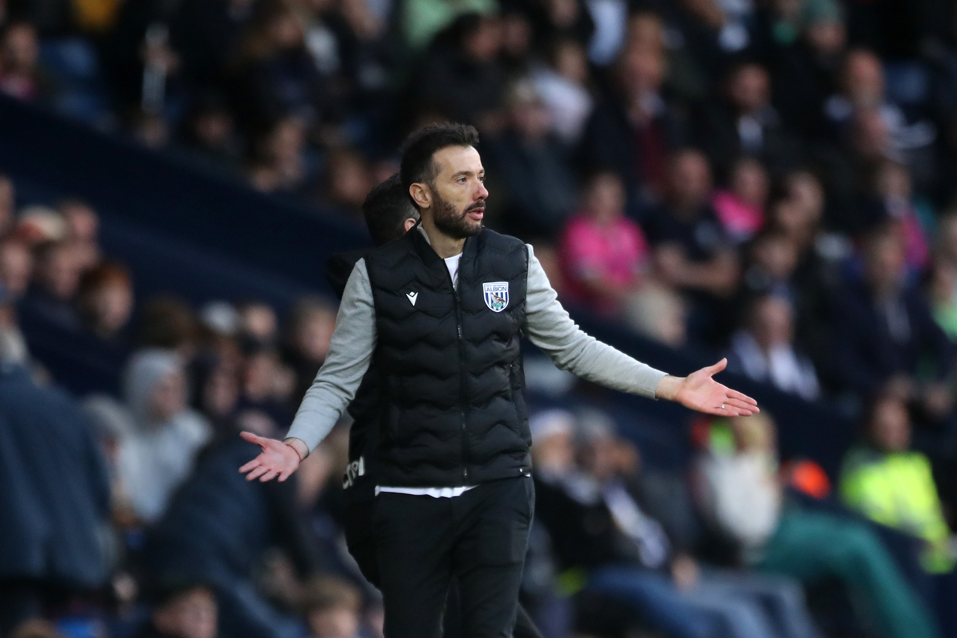 Carlos Corberán with his arms outstretched on the sidelines at The Hawthorns against Cardiff City 