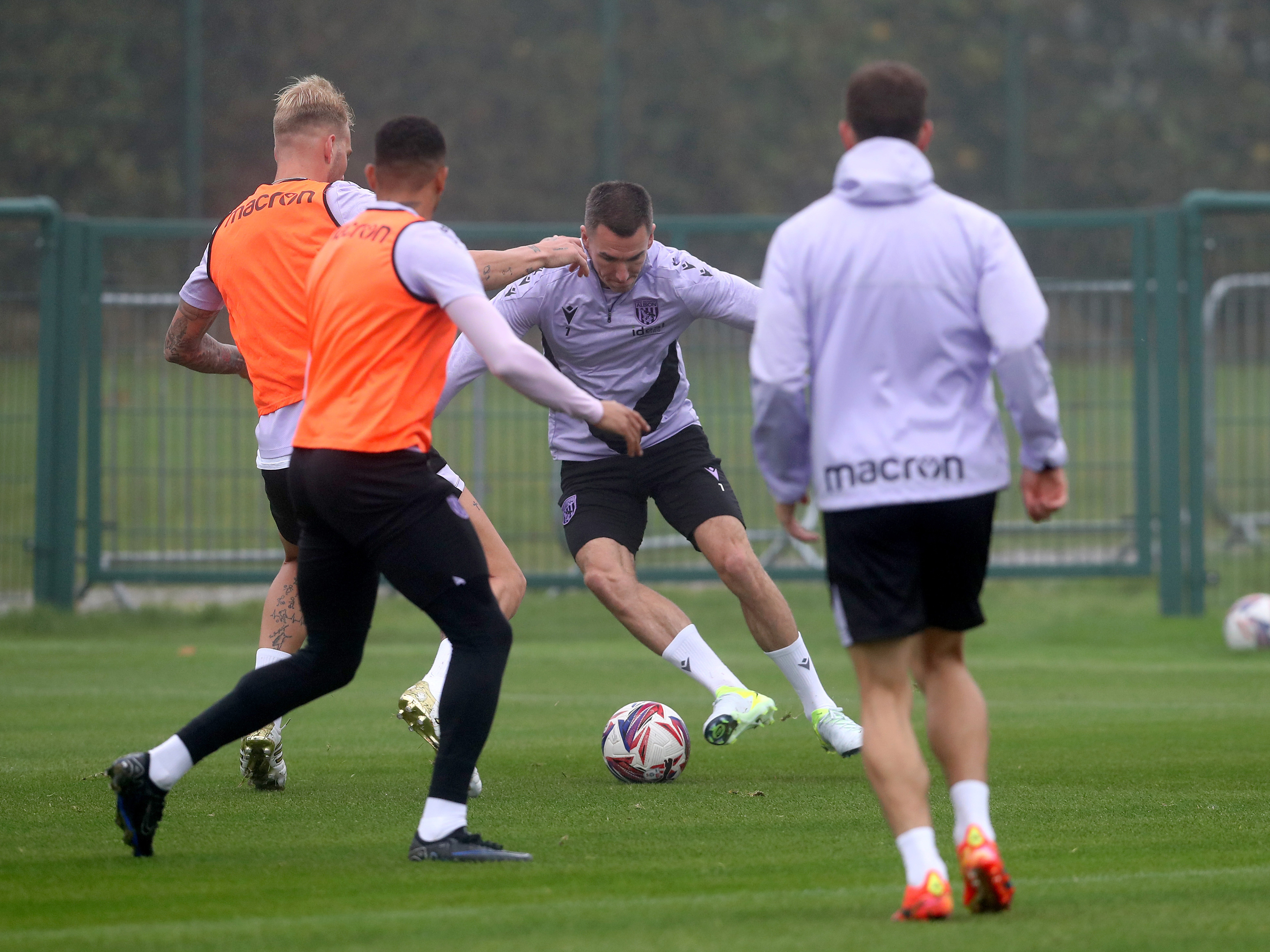 Jed Wallace on the ball surrounded by other players during a training session 