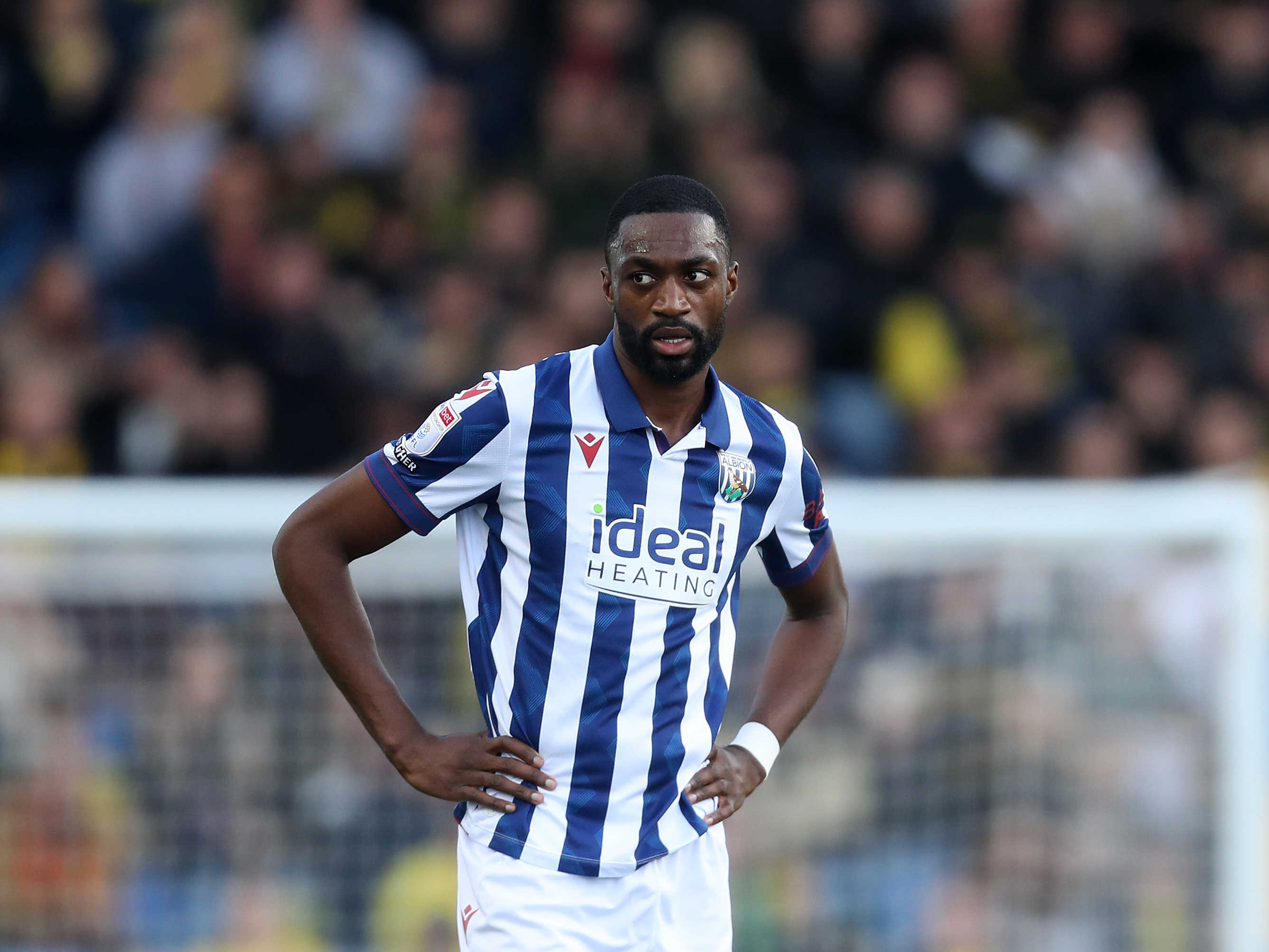 Semi Ajayi with his hands on his hips while wearing the home shirt in a game at The Hawthorns 