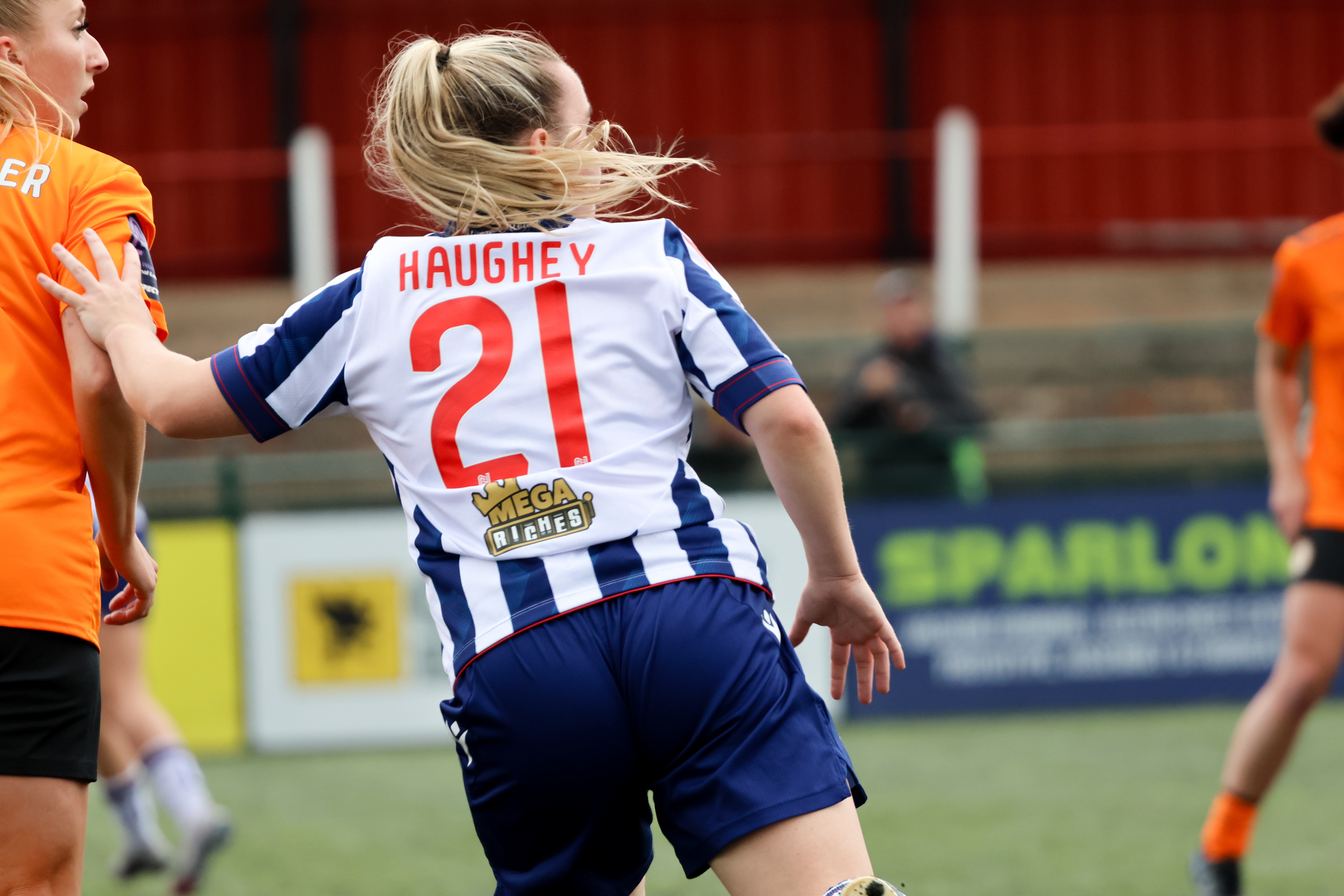 Ella Haughey's name and number on the back of her home shirt as she's in action 