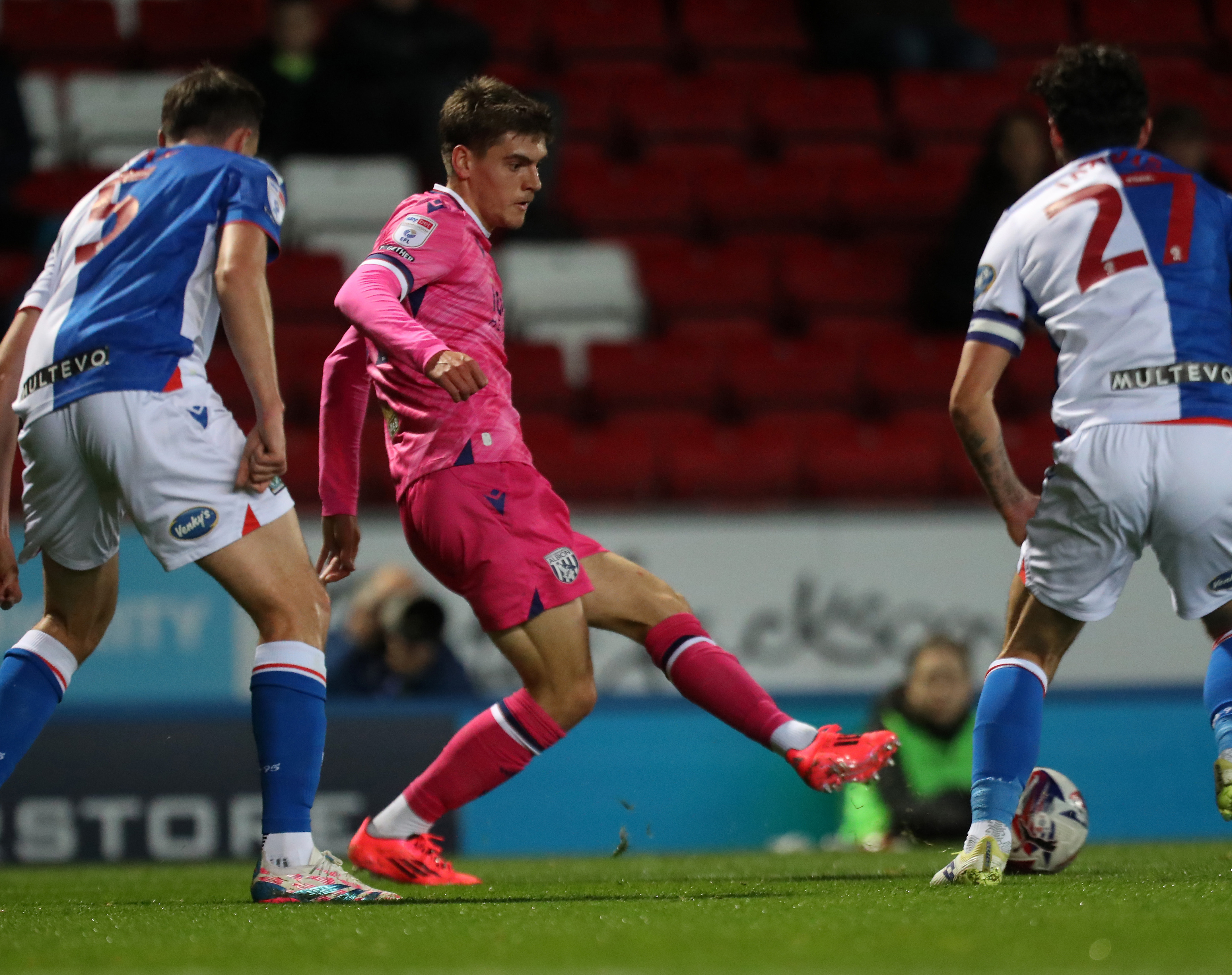 An image of Tom Fellows playing a pass against Blackburn