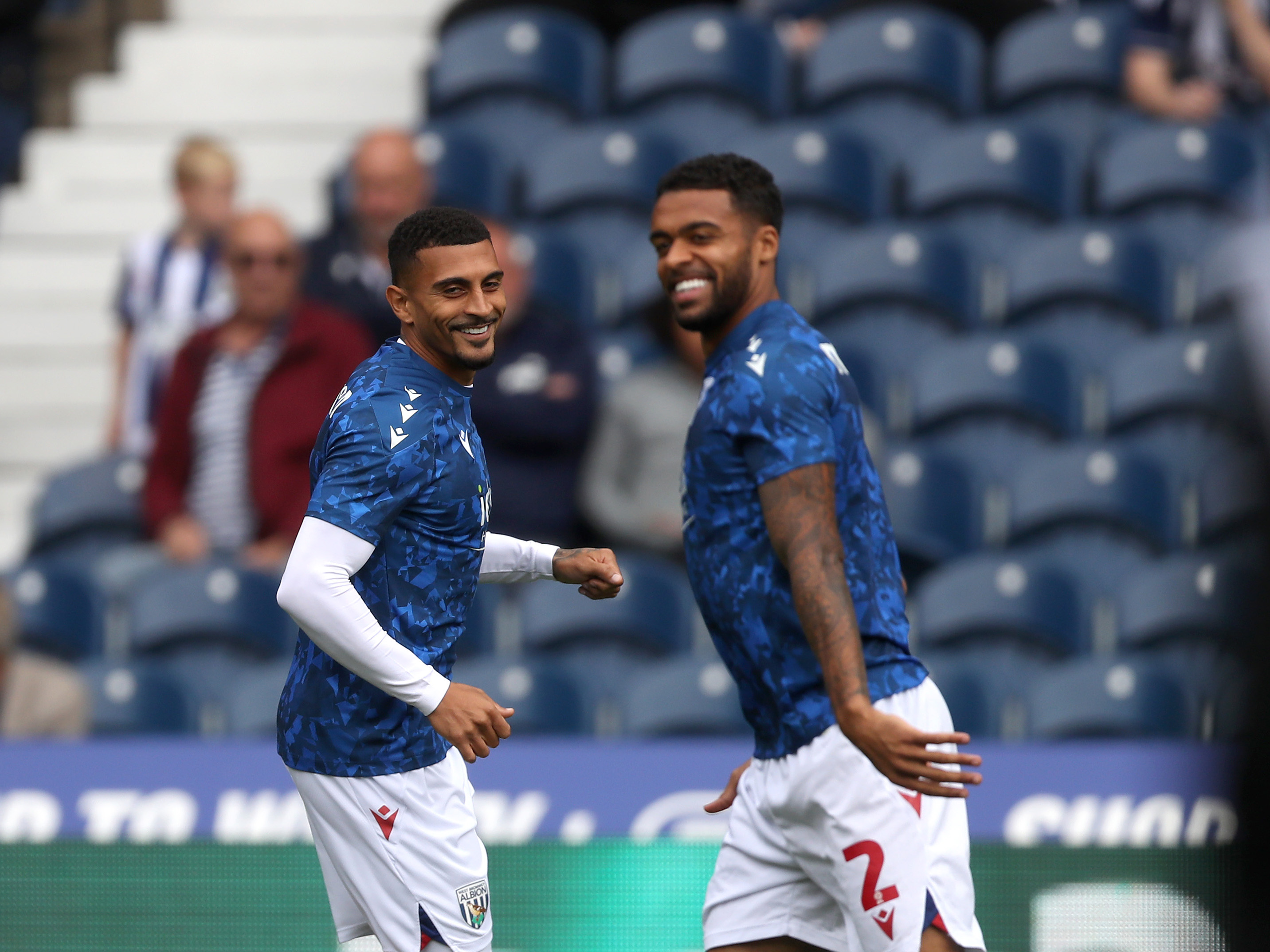 A photo of Darnell Furlong and Karlan Grant warming up at The Hawthorns