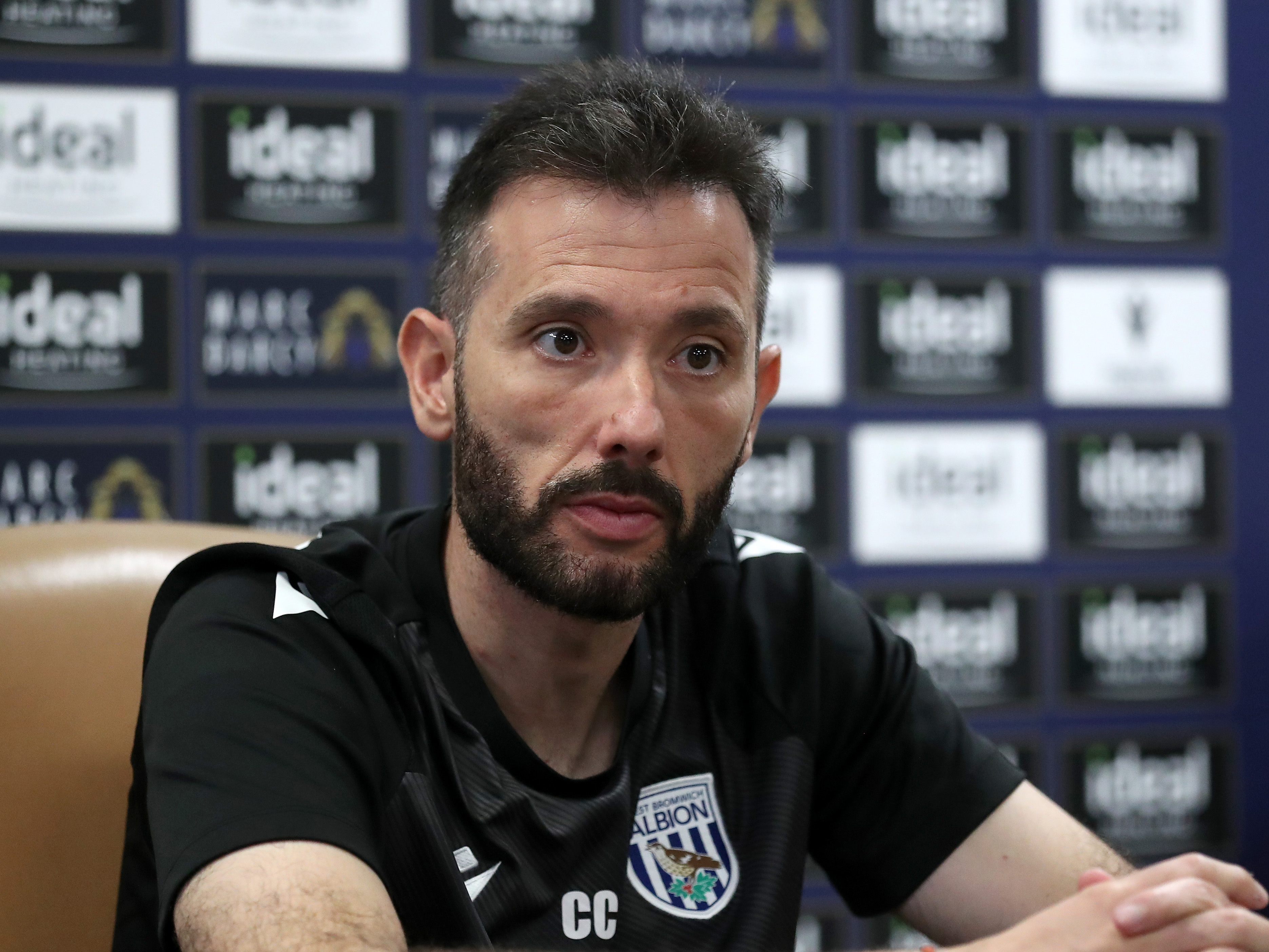 Carlos Corberán looking at the media during a press conference 