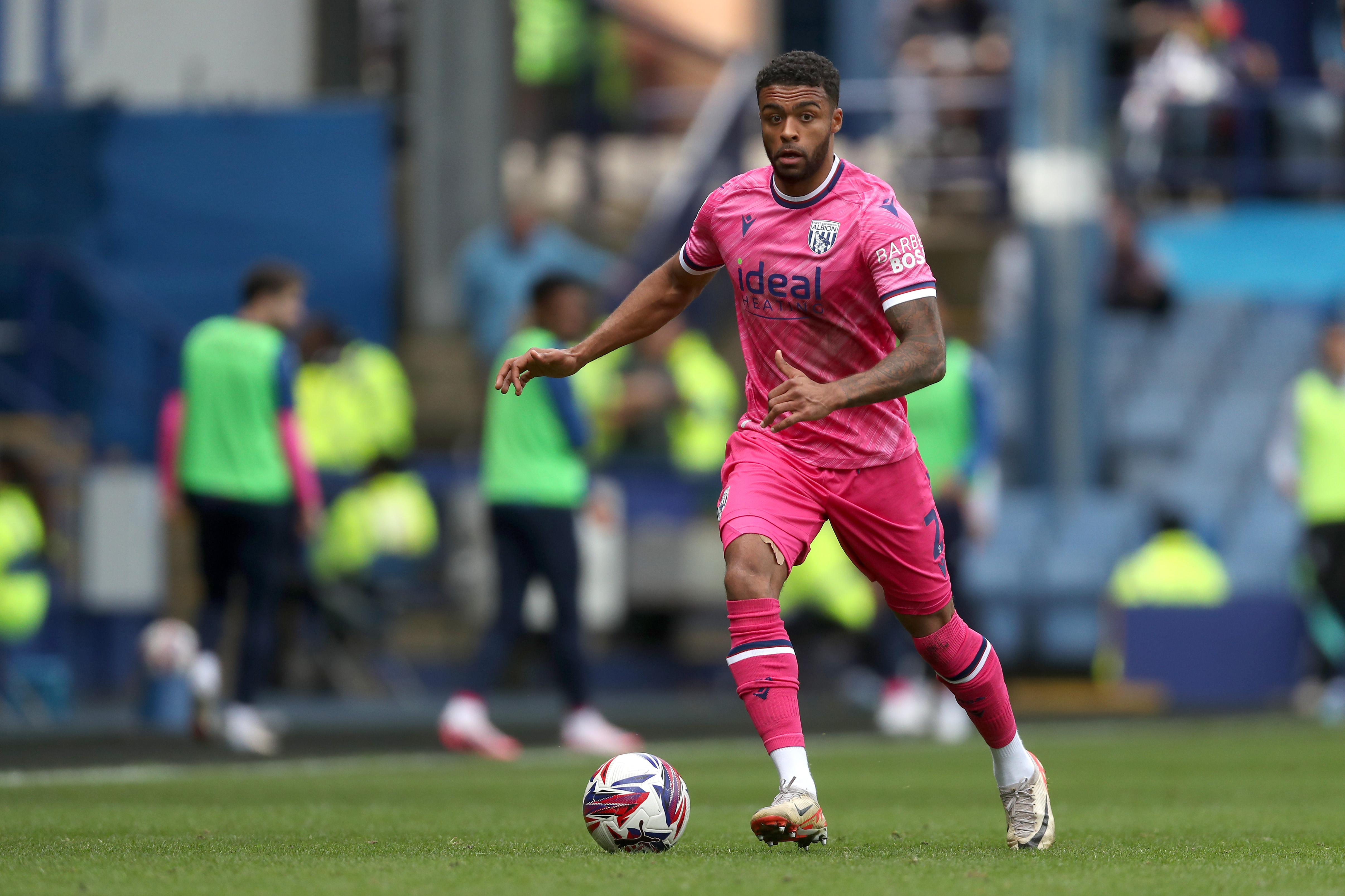 Darnell Furlong on the ball during a game against Sheffield Wednesday wearing the pink kit 