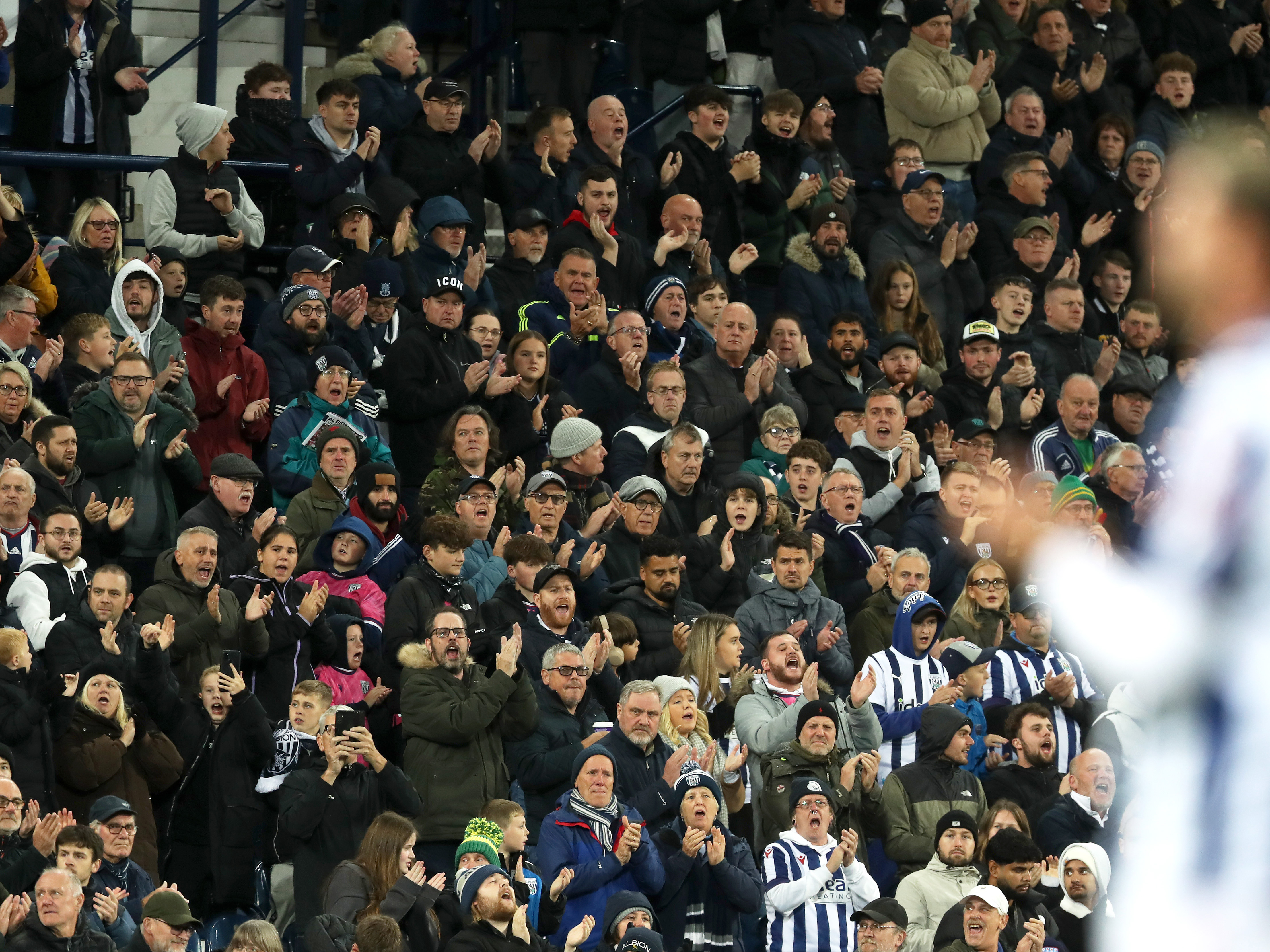 A general view of Albion fans in the stand at The Hawthorns applauding their team