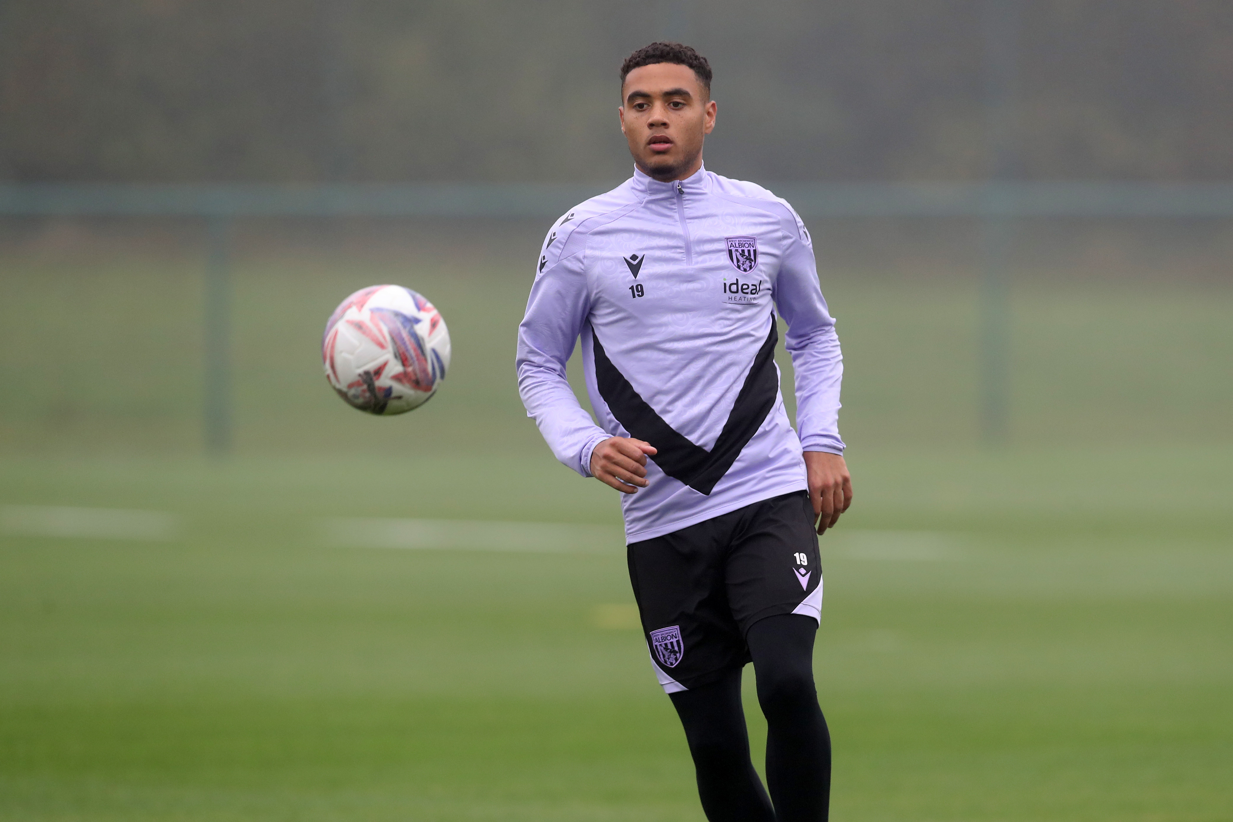 Lewis Dobbin looking at a ball in mid-air during a training session 