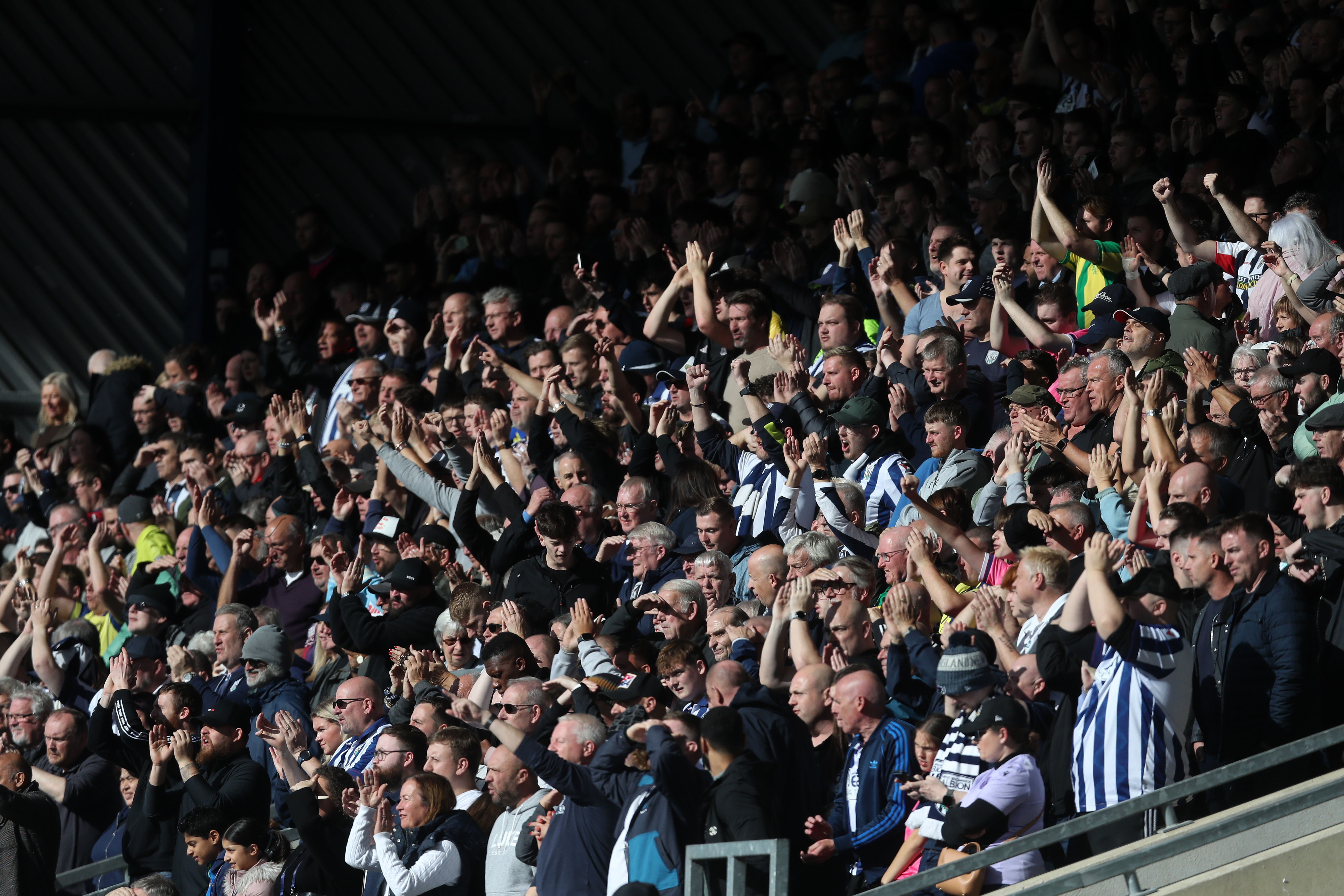 A general view of Albion fans in the stand applauding their team 