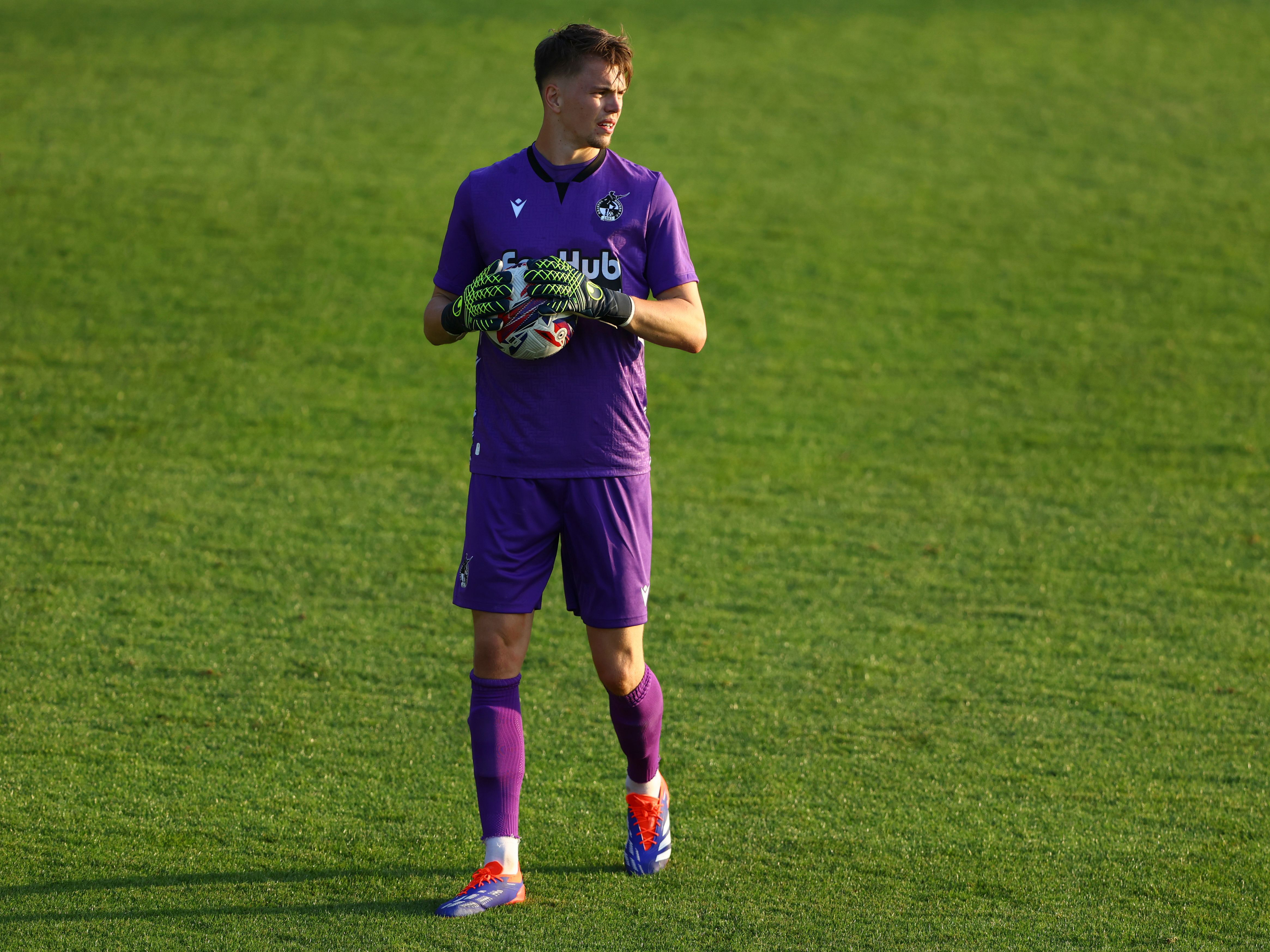 A photo of goalkeeper Josh Griffiths in action for loan club Bristol Rovers, wearing a purple goalkeeping kit