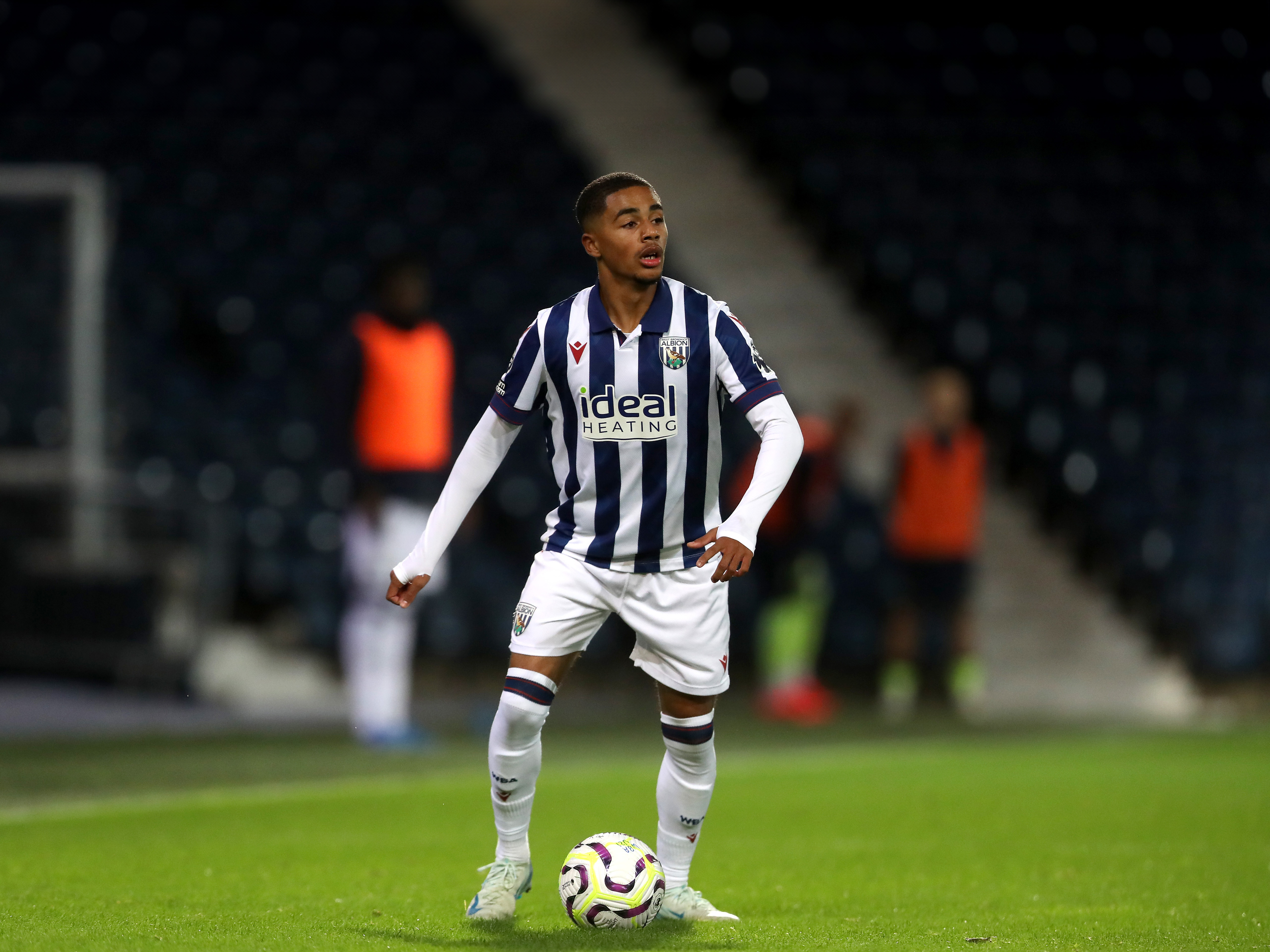 A photo of Albion u21 defender Deago Nelson in the 2024/25 home kit in action at The Hawthorns