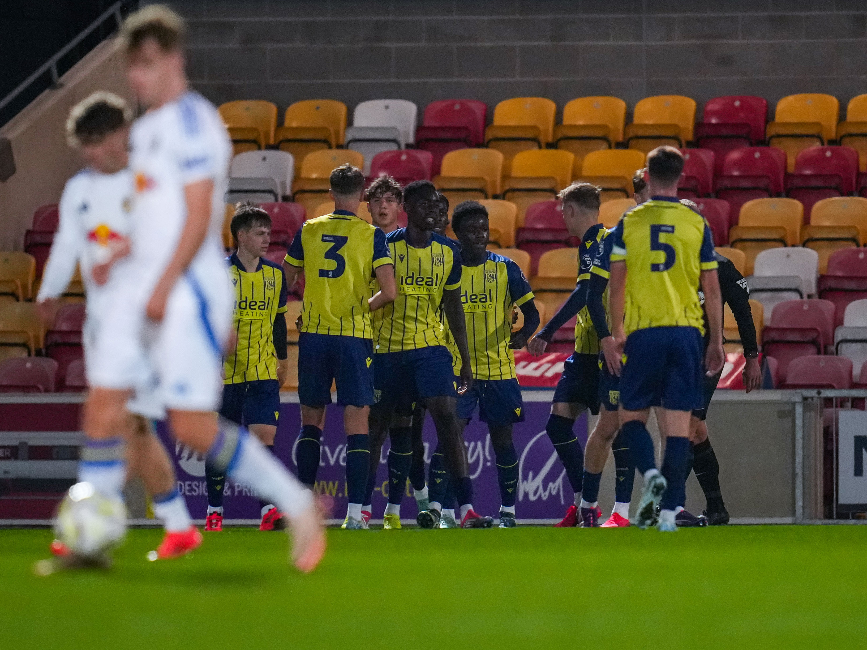 A photo of Albion U21s, in the yellow and blue 2024/25 away kit, celebrating a goal v Leeds