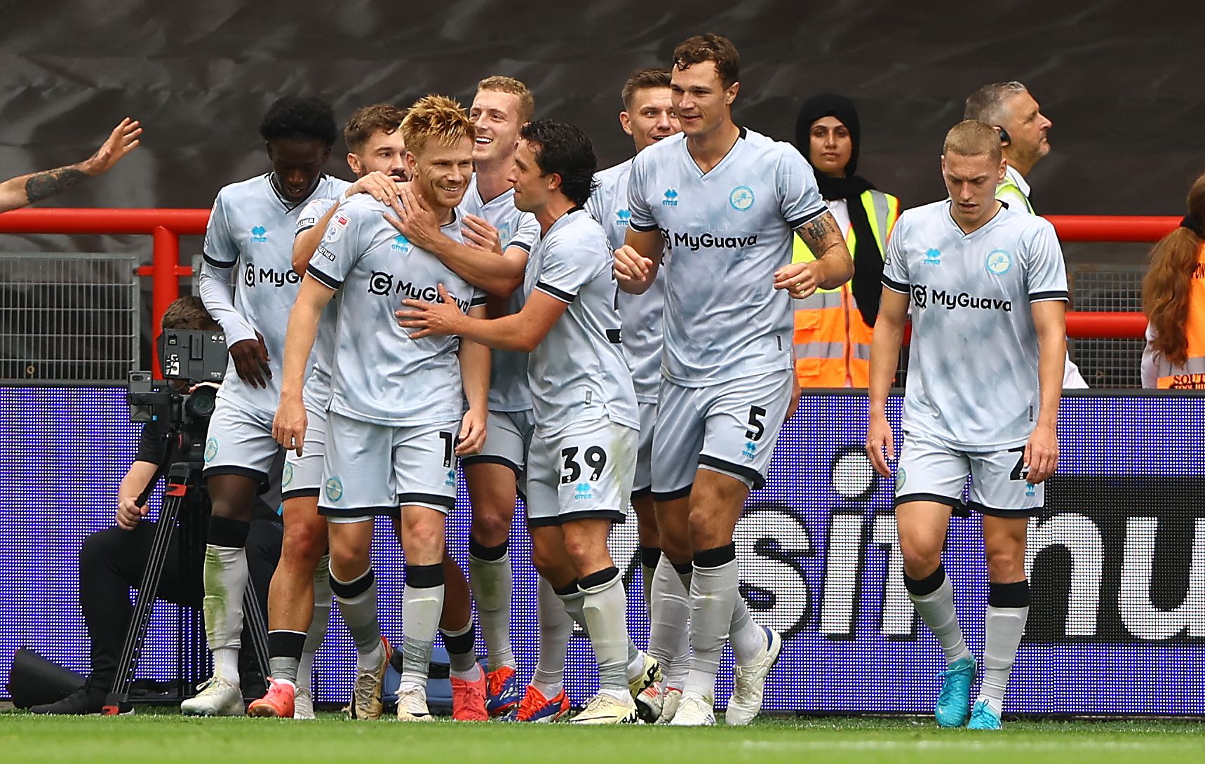 Several Millwall players celebrate a Millwall goal in the away kit 