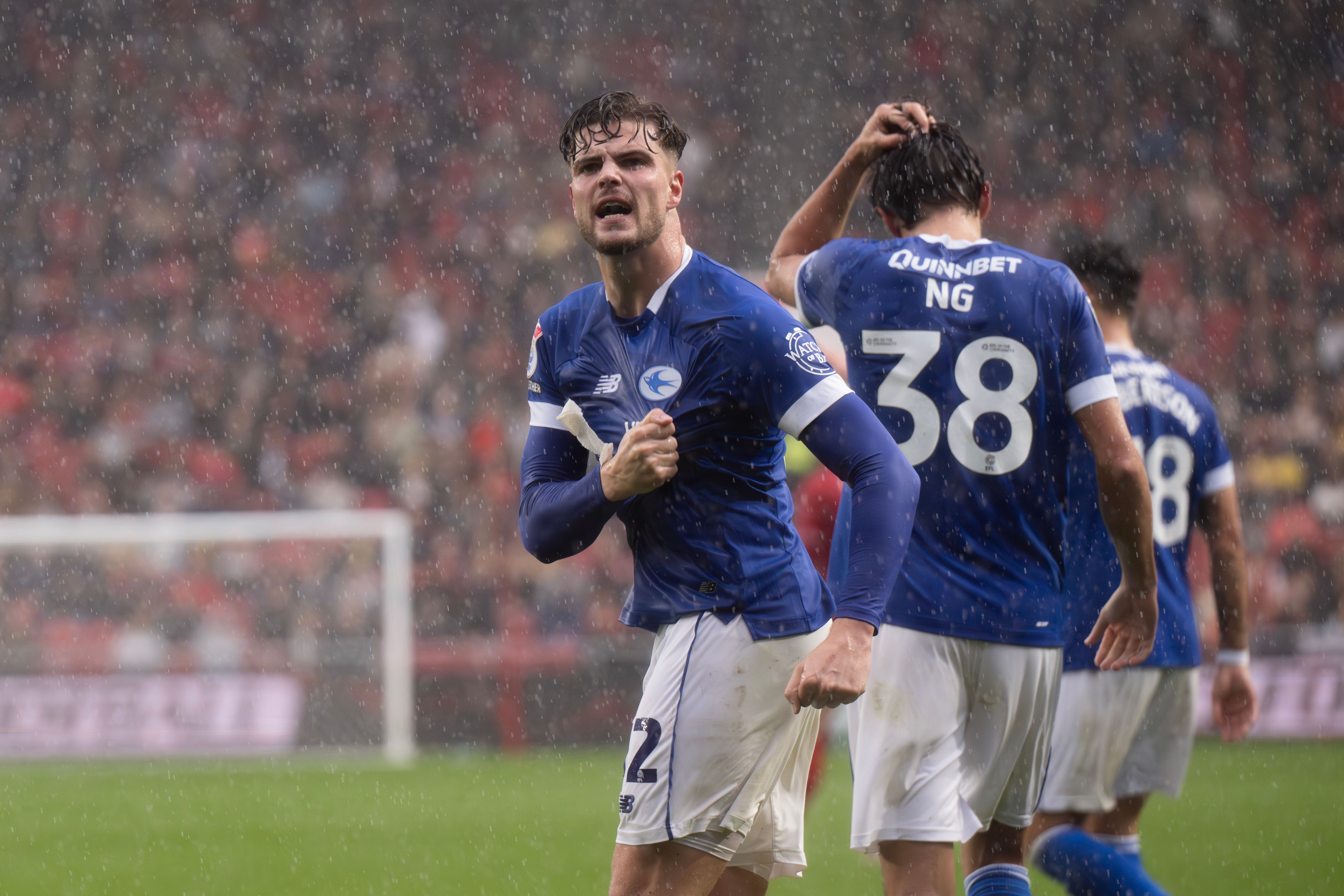 Cardiff City's Ollie Tanner celebrates scoring a goal in the rain 