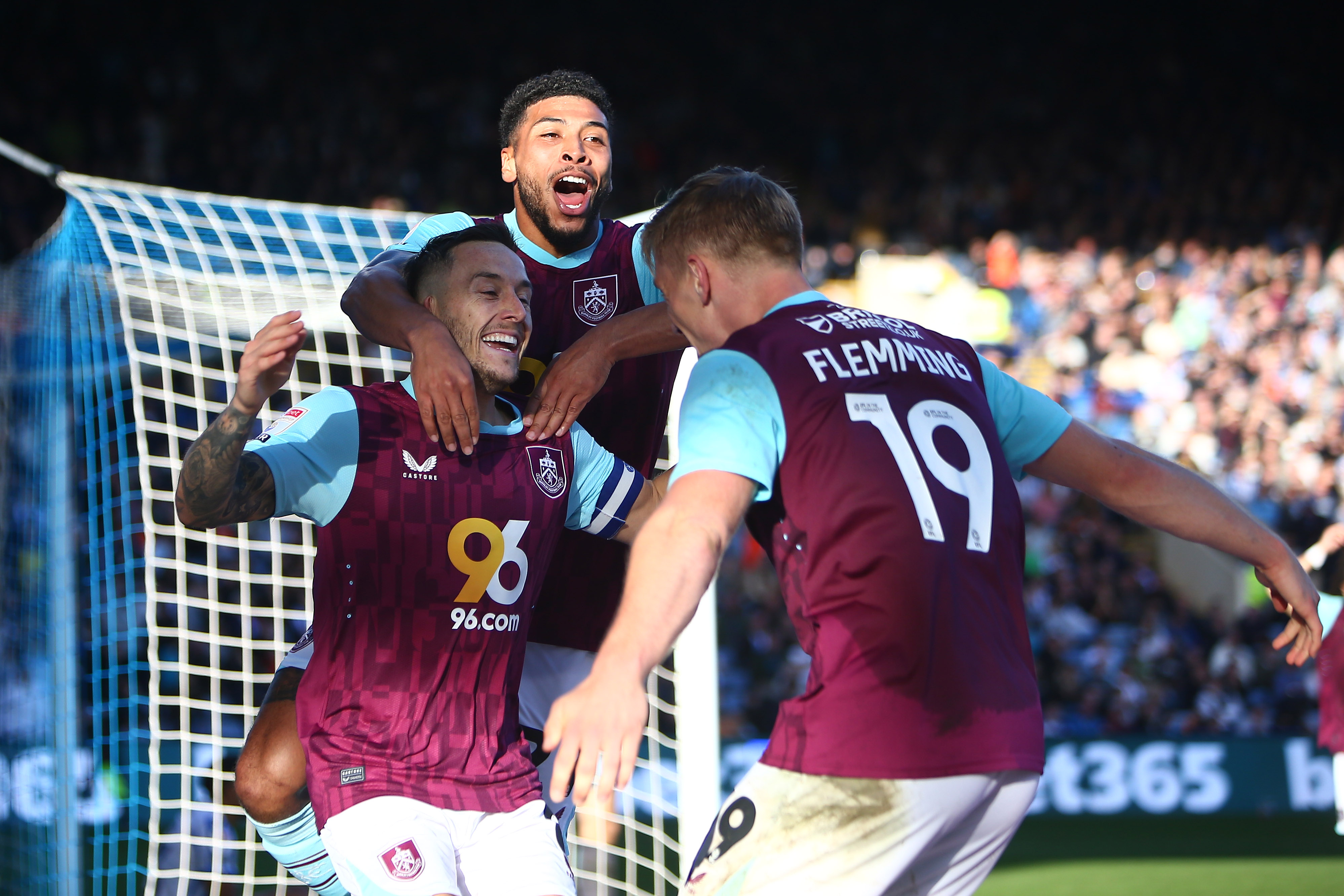 Josh Brownhill of Burnley celebrates scoring with two of his team-mates 