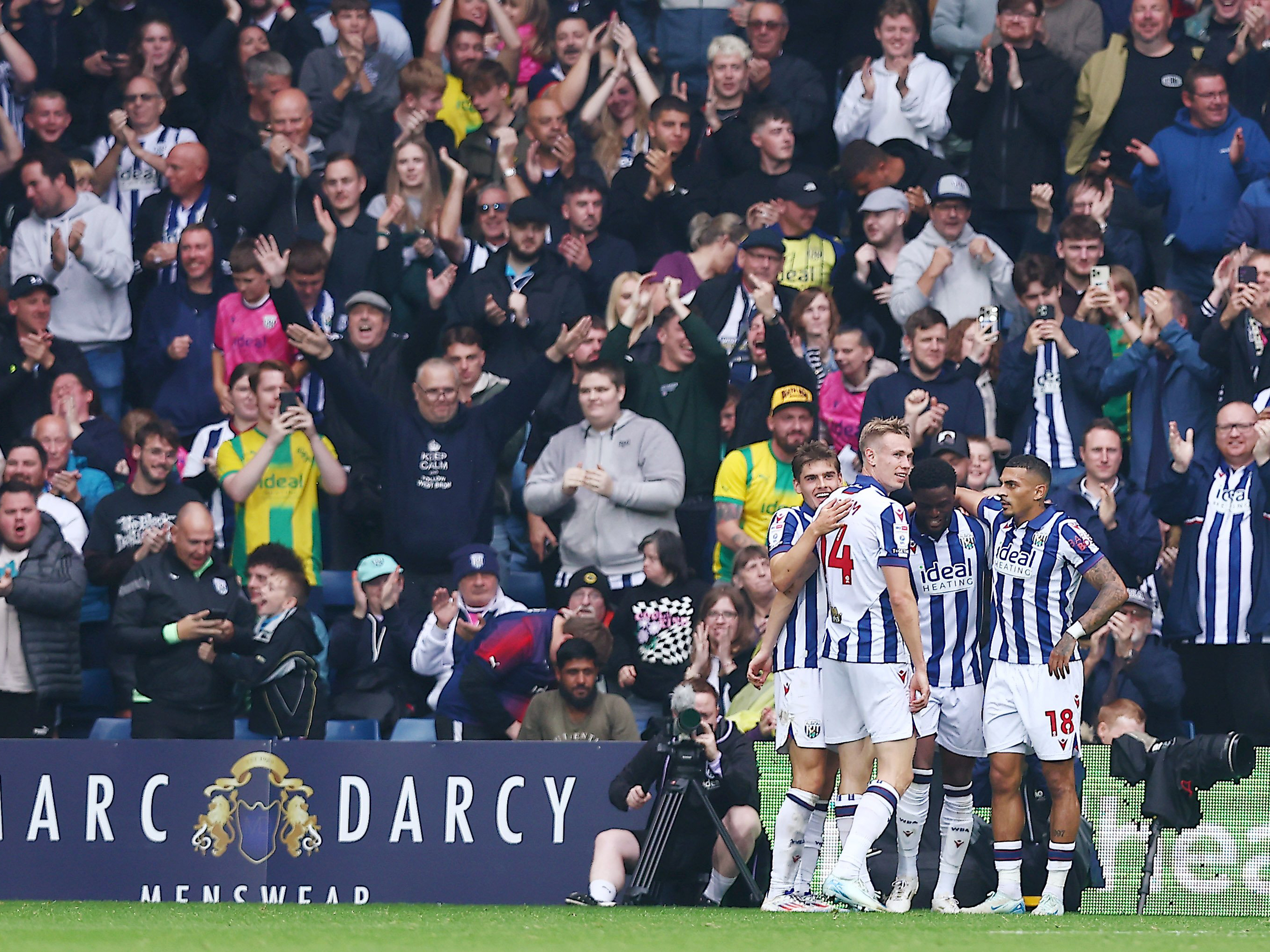 An image of Albion celebrating a goal with their supporters