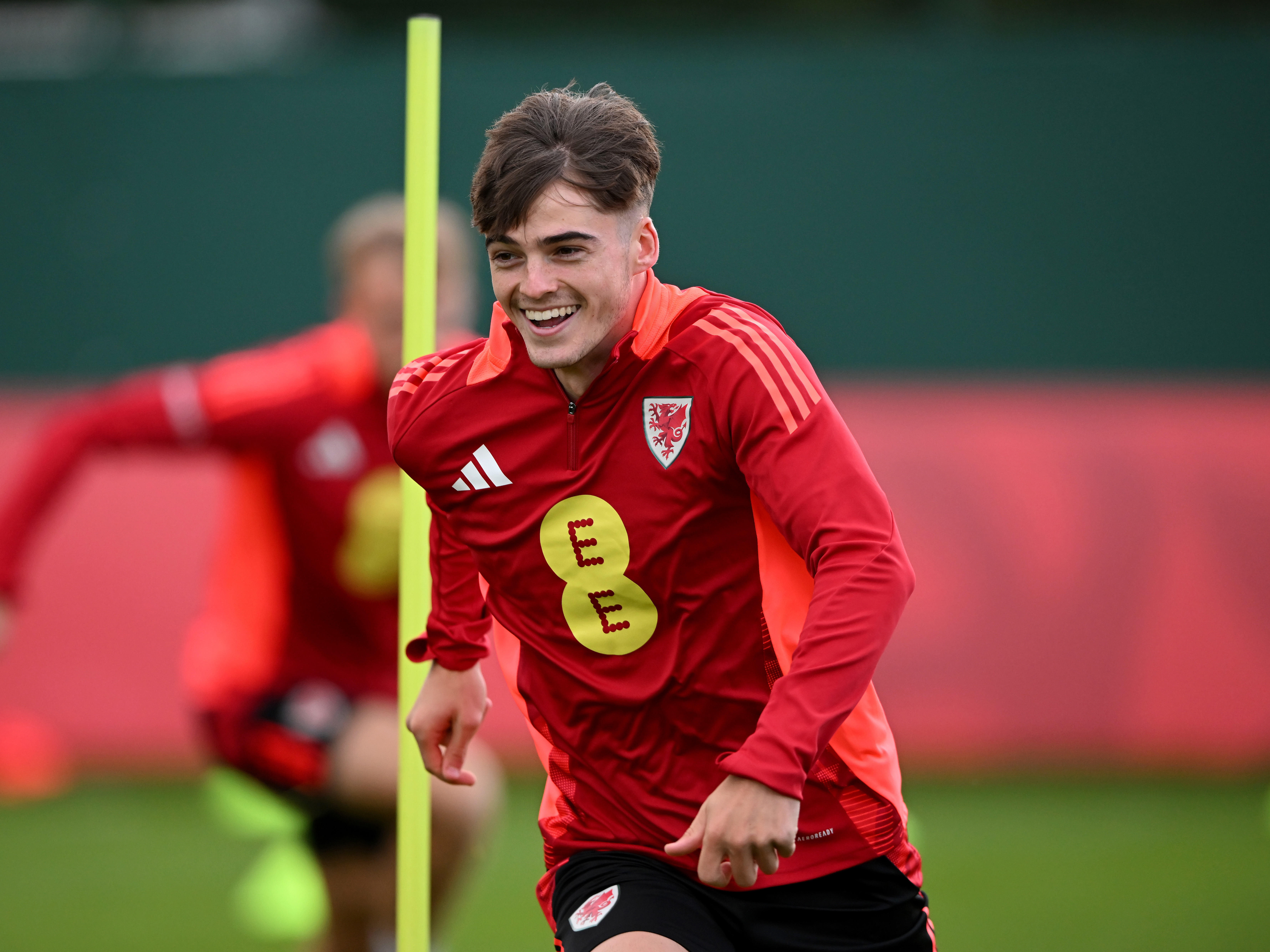 A photo of U21s defender Alex Williams in training for Wales, wearing the red training gear of the national team