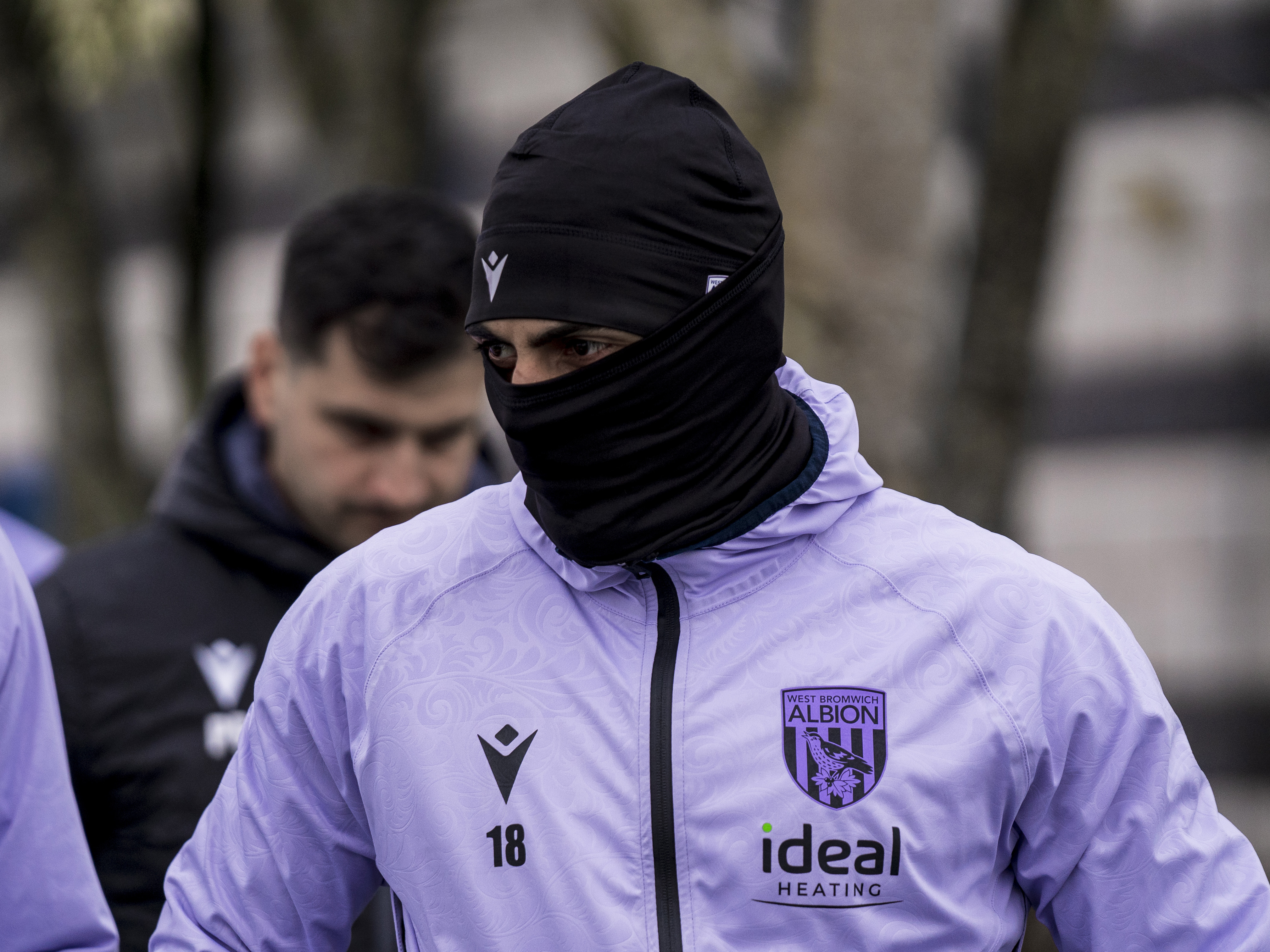 Karlan Grant heading out to training wearing a hat and a snood