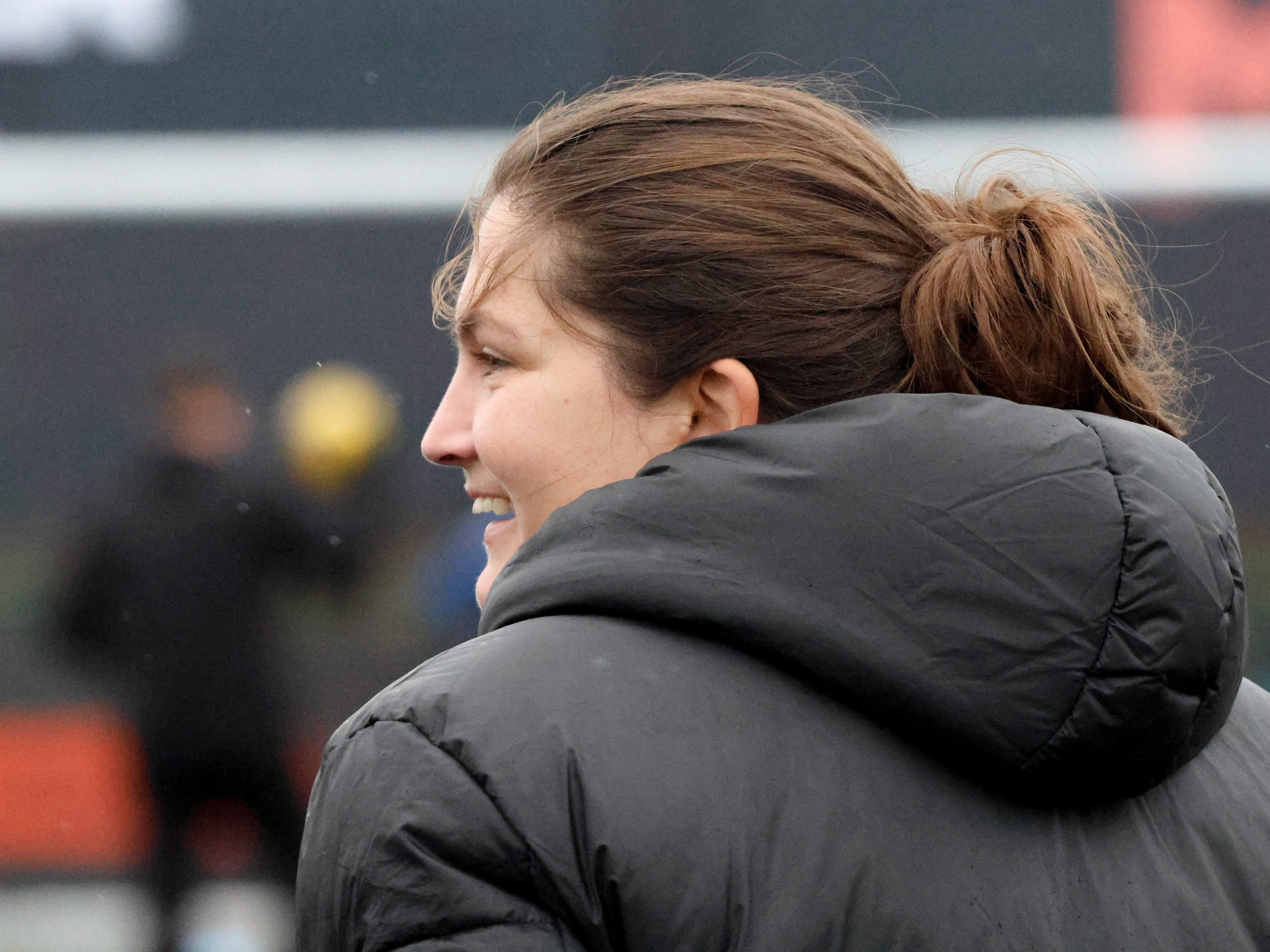 Siobhan Hodgetts-Still on the side of the pitch smiling 