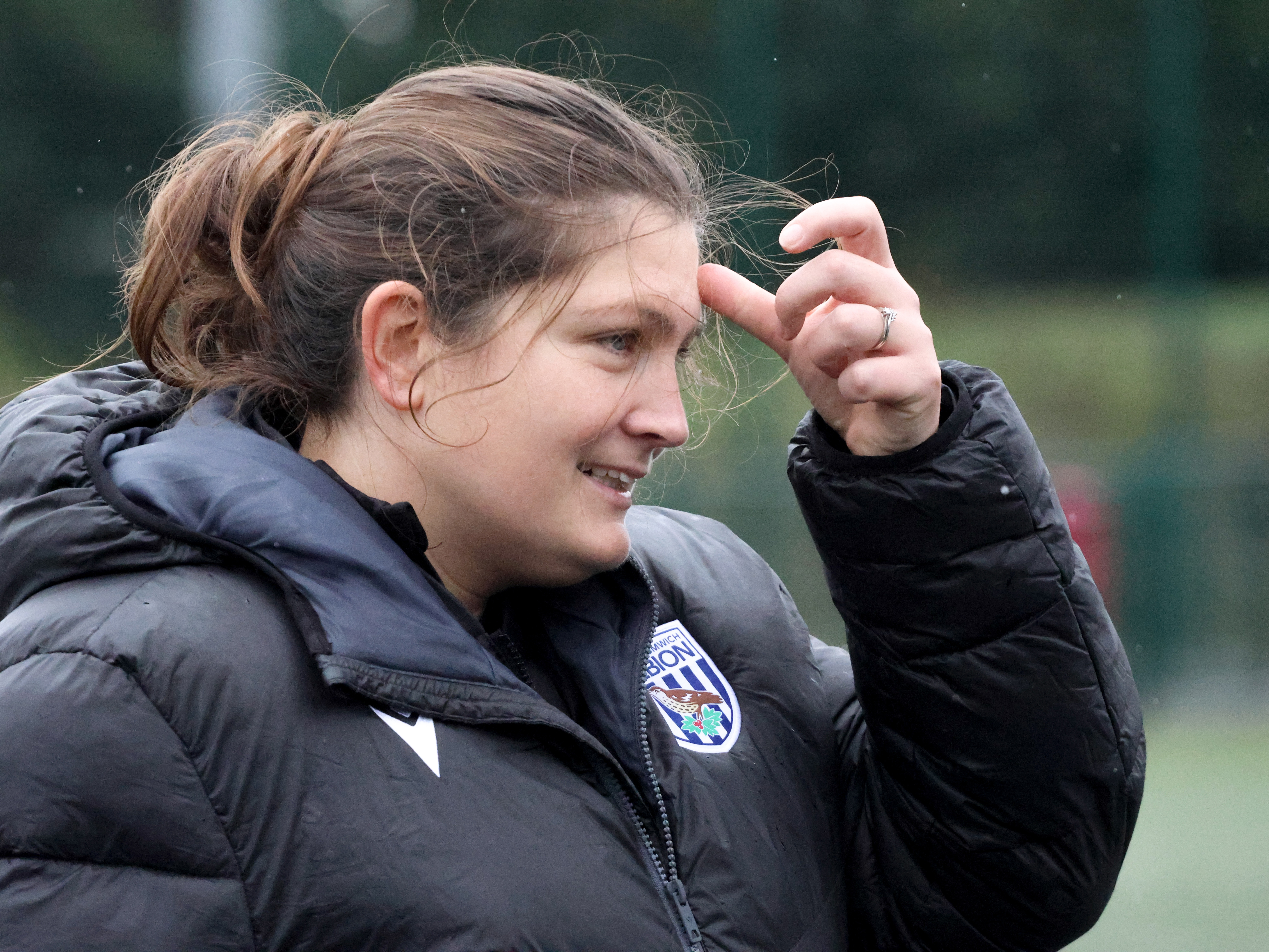 Siobhan Hodgetts-Still on the side of the pitch smiling 