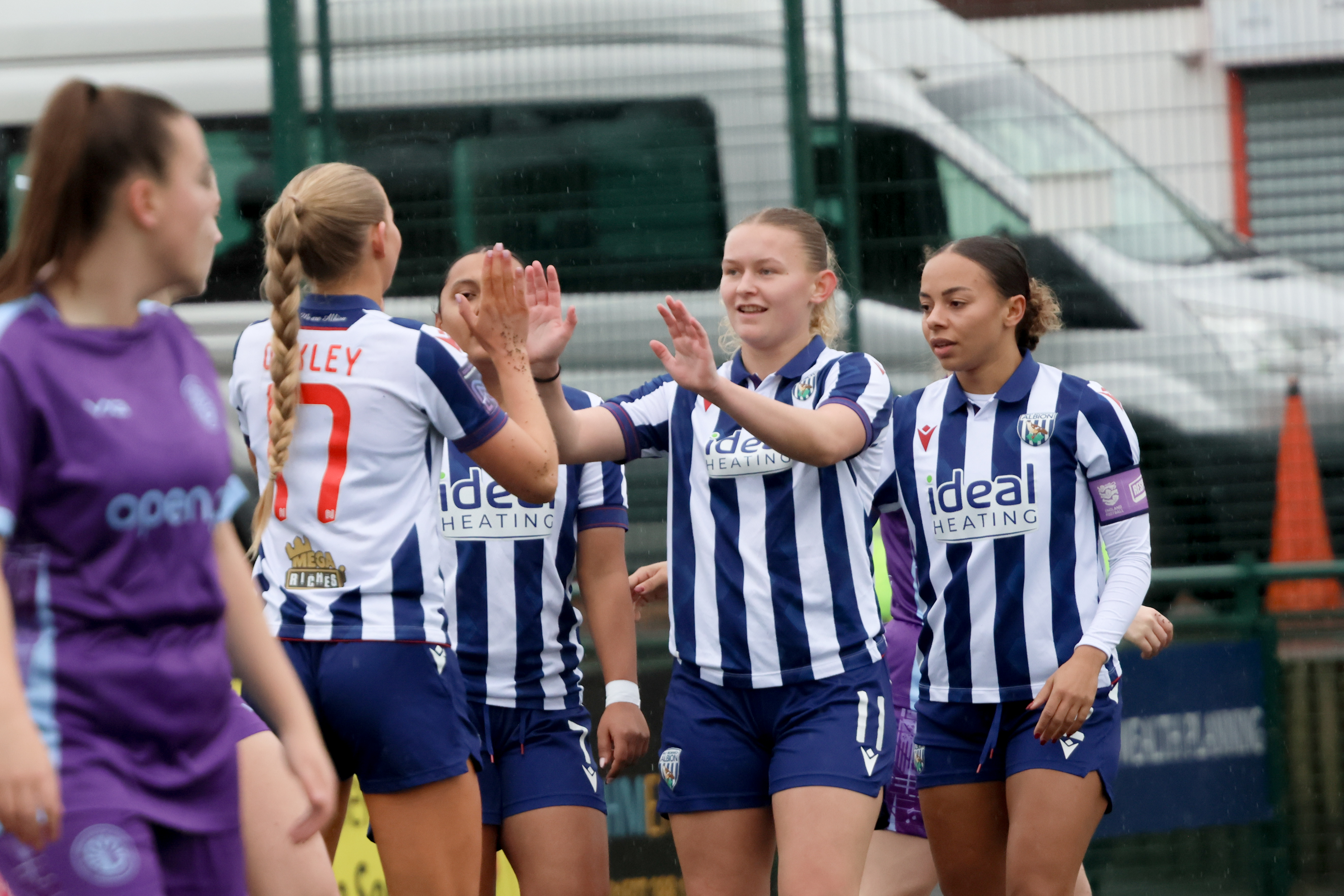 Marli Rhodes celebrates scoring for Albion Women in the home kit with three team-mates 