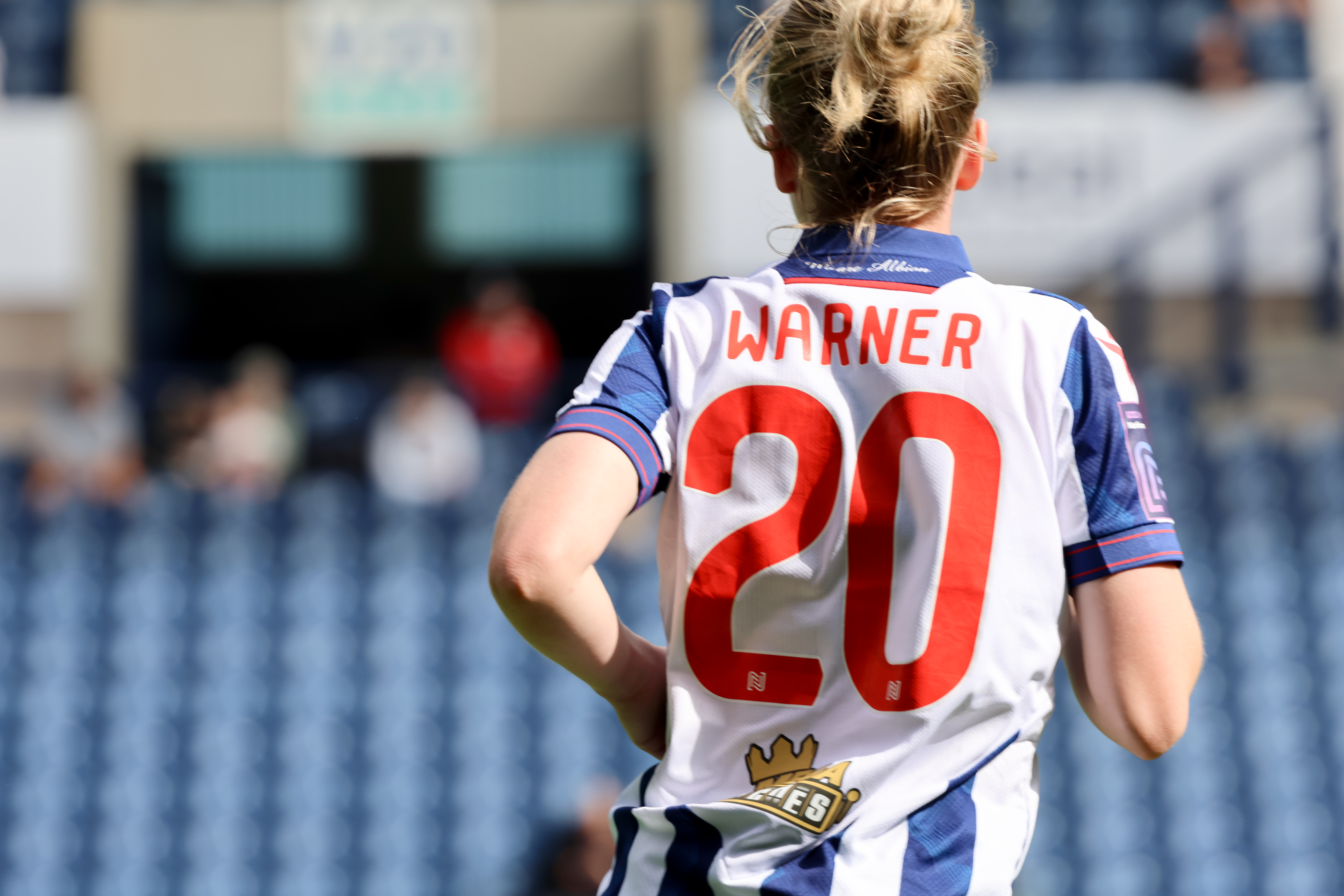 The back of Phoebe Warner's home shirt during a game with her name and No.20 on display