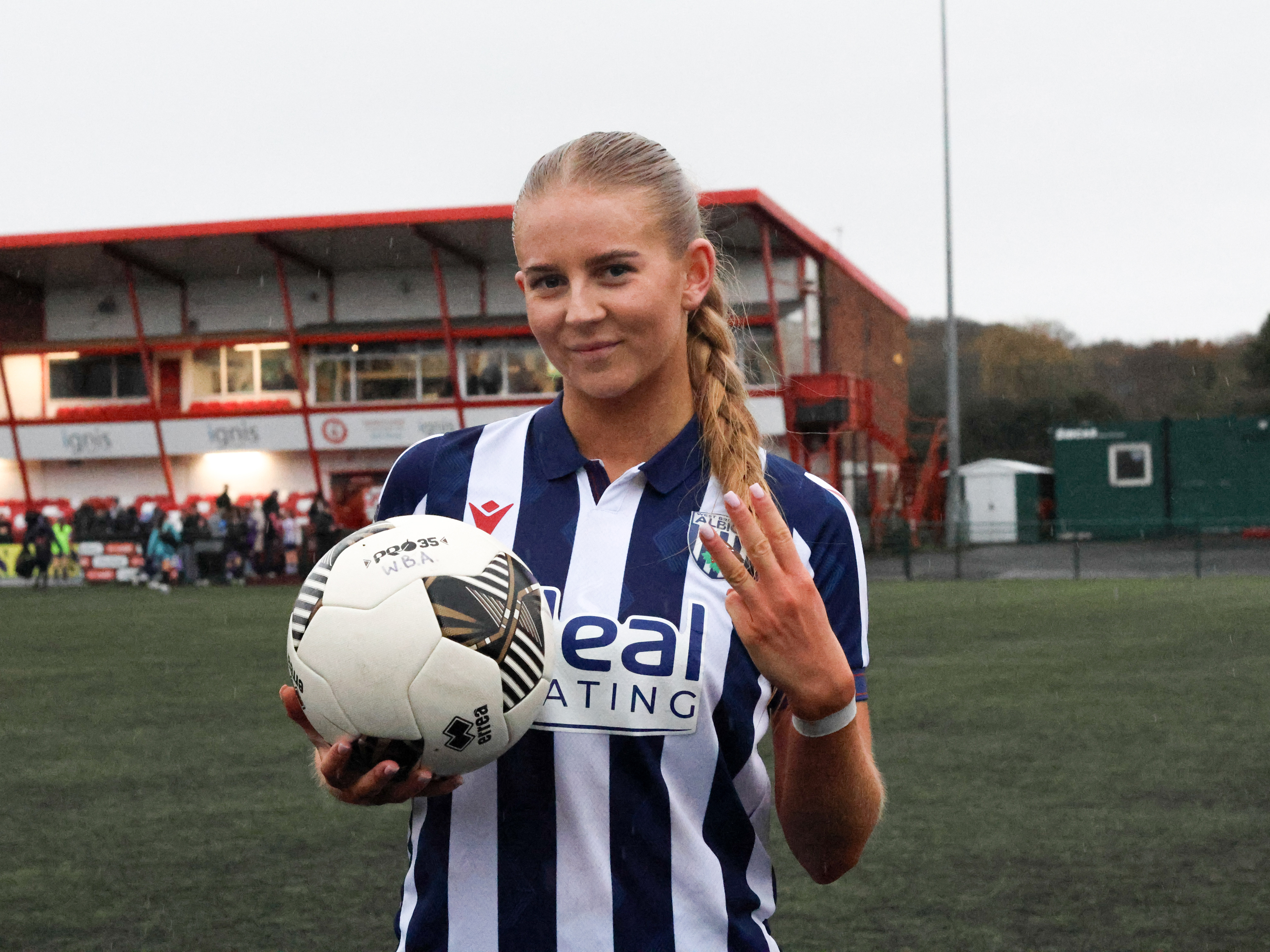 Rhianne Oakley posing for a photo with a signed matchball after scoring a hat-trick 